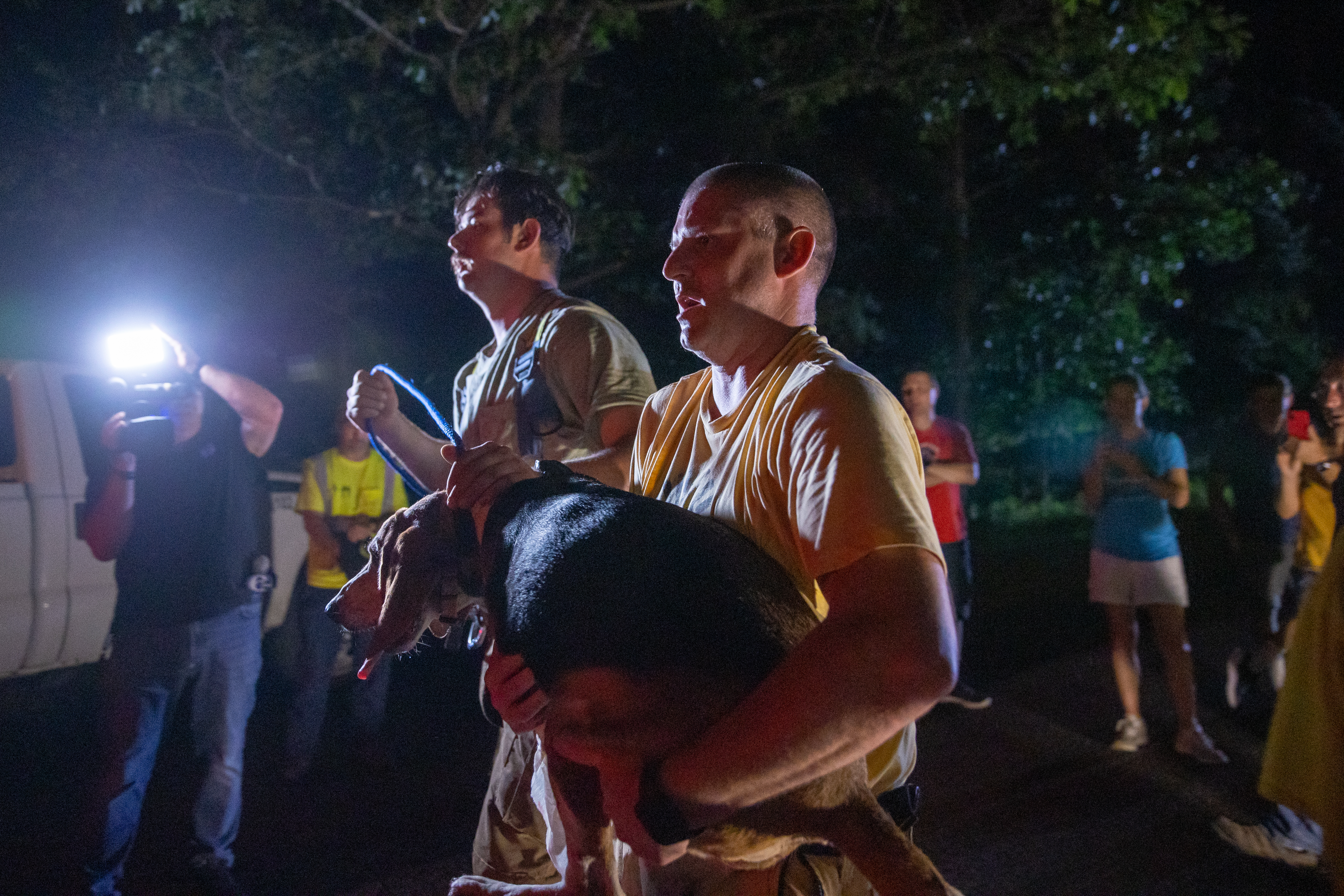 Medford Fire and EMS Chief Rob Dovi, right, and Lieutenant Chris Rabbuttino carry Dylan, an 8 year old coonhound lost for a week, to an awaiting police car after rescuers removed the dog from 140-150 feet into an 18 inch drain pipe in Medford, NJ on Saturday, July 23, 2022. Dylan was rescued after 5 hours and 47 minutes in a group effort that included Medford fire, police, public works, and members of the community.
