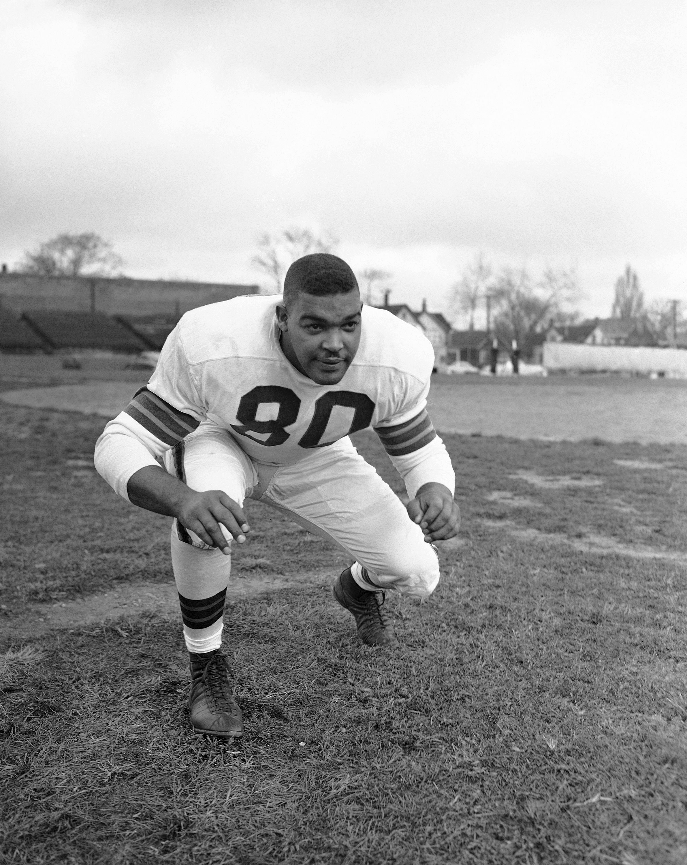 Marion Motley (76), Cleveland fullback, picked up 12 yards and a first down  in the fourth period before he was tackled by Paul Younger, Los Angeles  halfback at Cleveland on Dec. 24