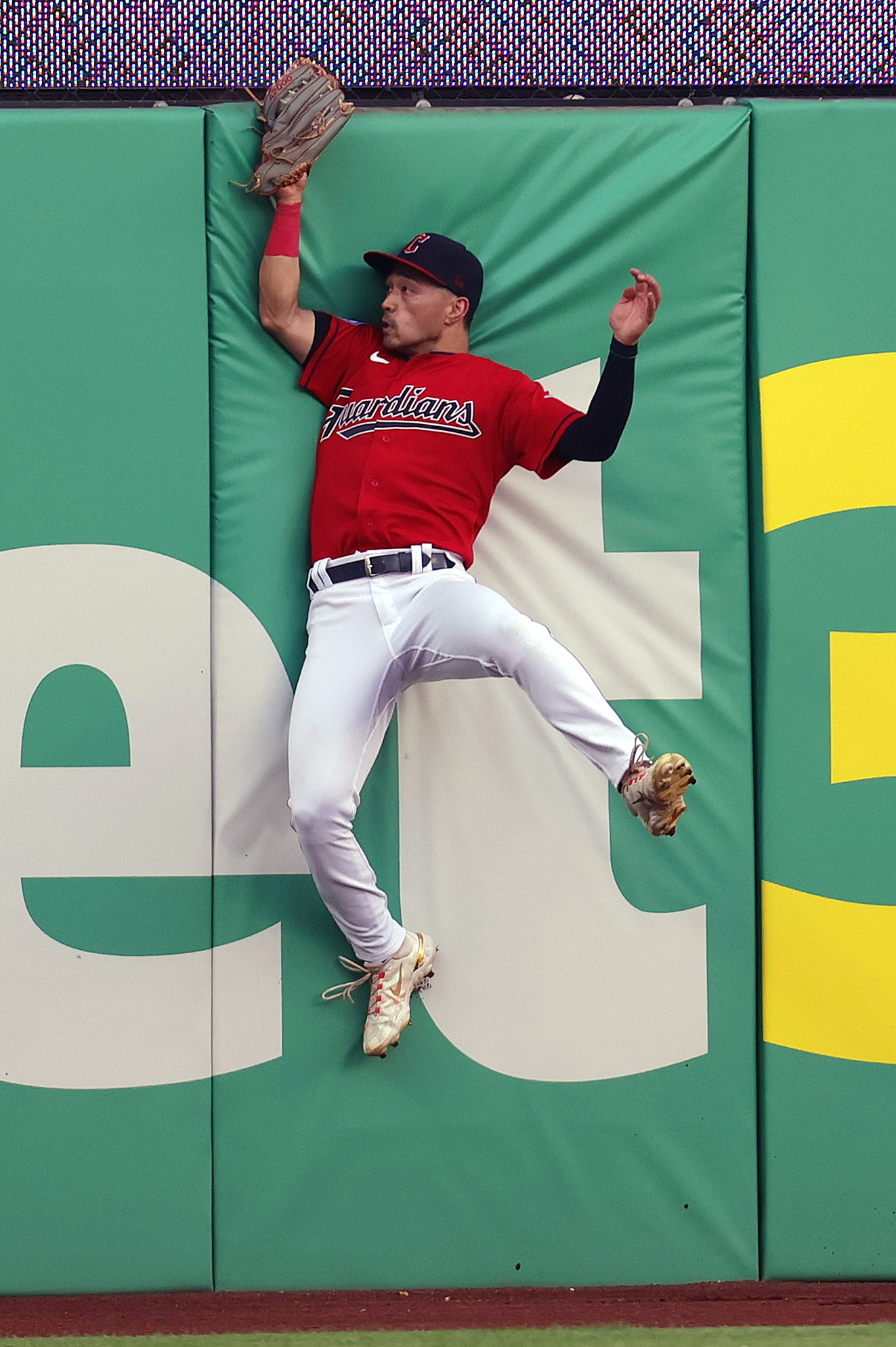 Cleveland Guardians left fielder Steven Kwan leaps up towards the outfield wall to catch a long fly ball for the out off the bat of Tampa Bay Rays third baseman Taylor Walls