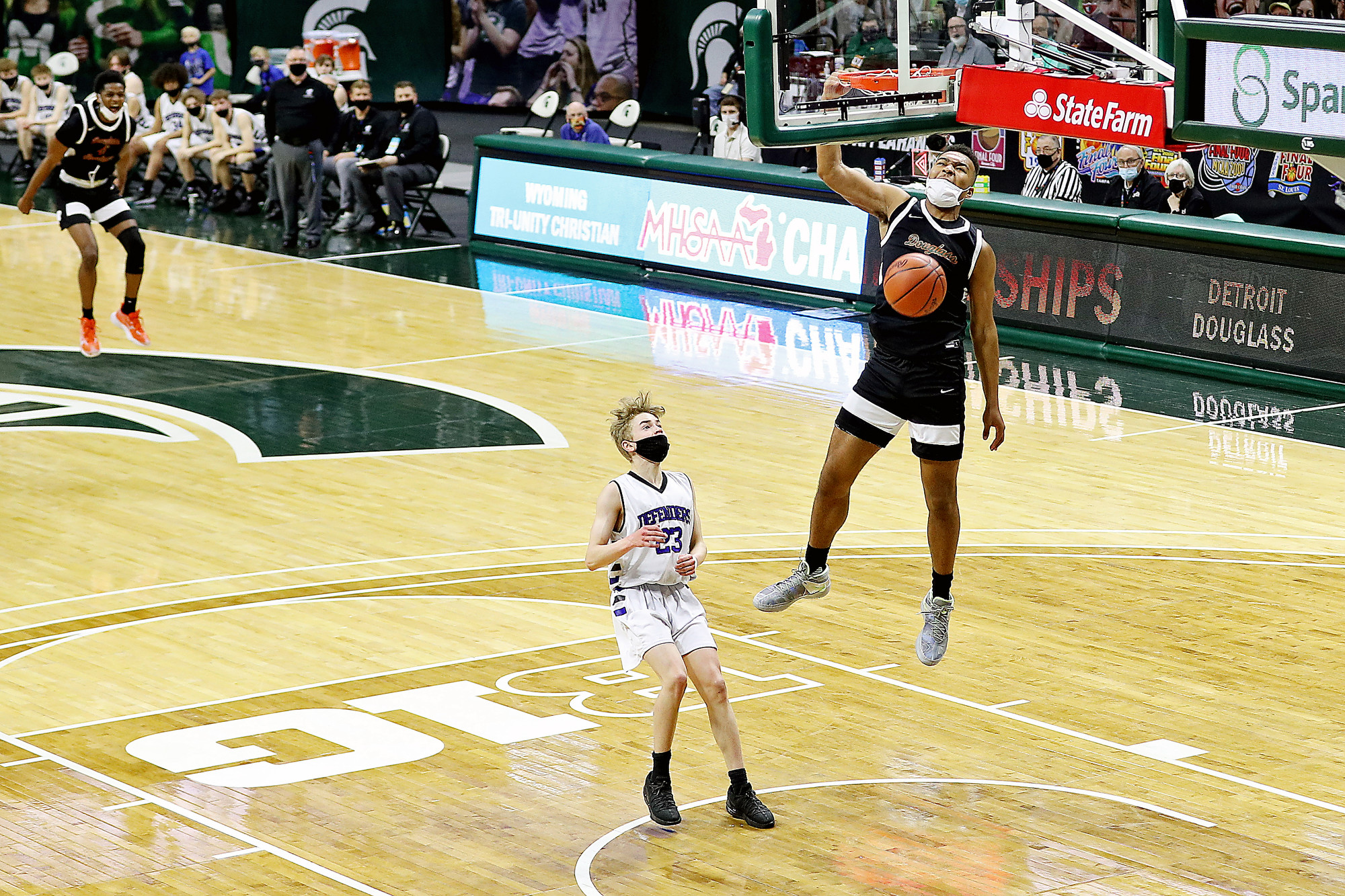 Photos of Detroit Douglass basketball player Pierre Brooks II