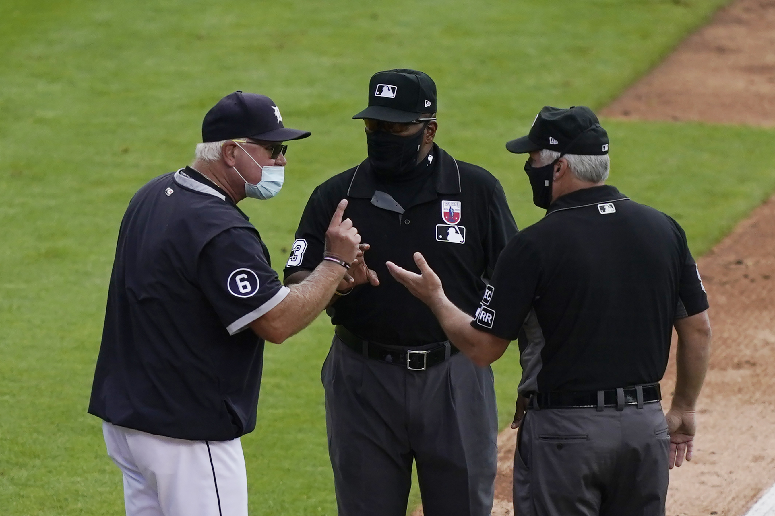 MLB umpire Laz Diaz looks to throw a baseball into the stands