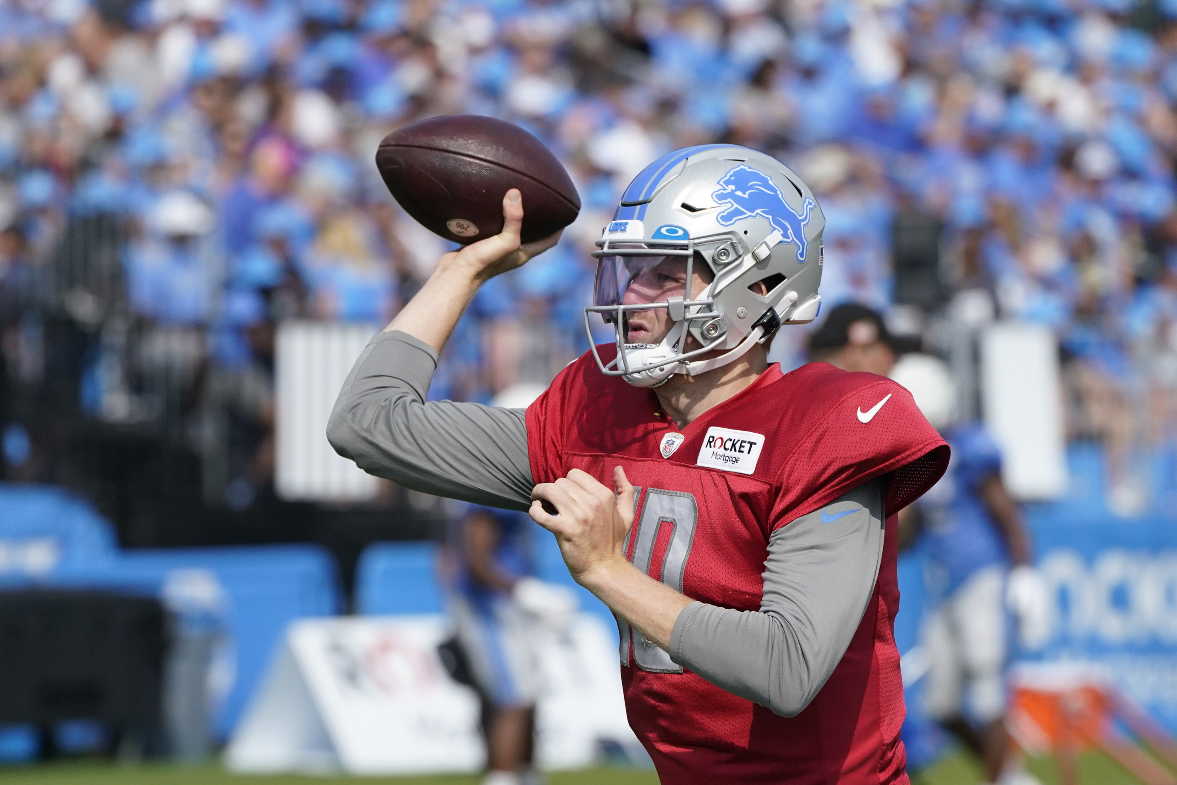 Detroit Lions quarterback Adrian Martinez (18) keeps the ball