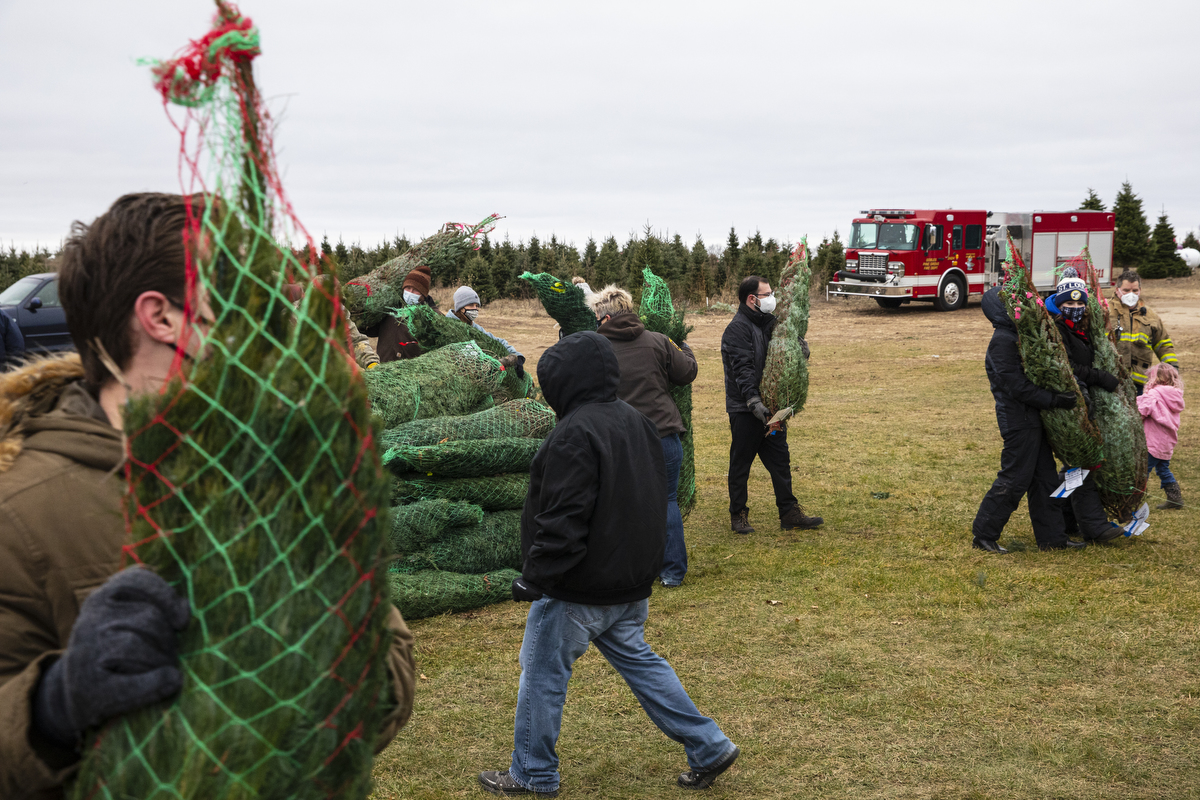 Volunteers gather to load Christmas trees for 'Trees for Troops