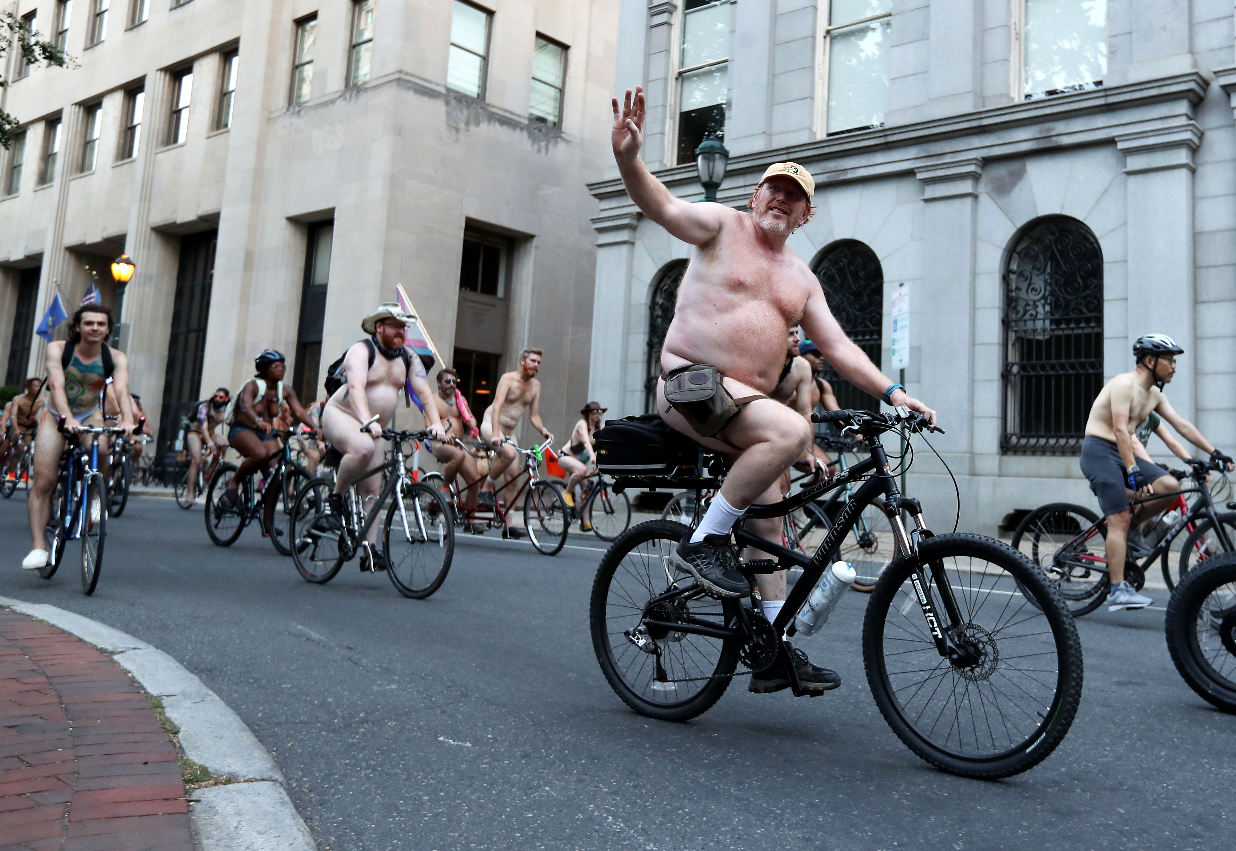 People ride bikes around Washington Square in Philadelphia during the Philly Naked Bike Ride, Saturday, Aug. 27, 2022.