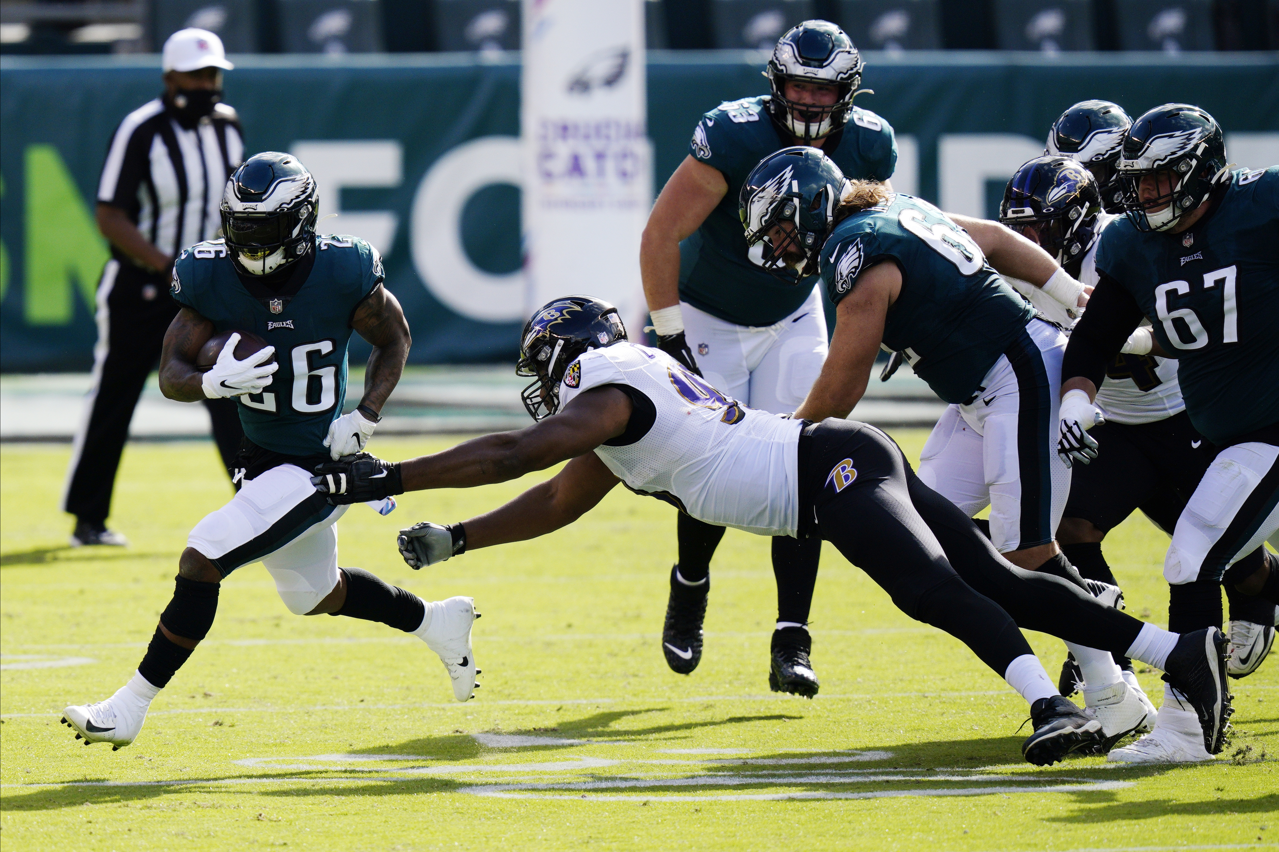 Philadelphia Eagles' Miles Sanders has helmet ripped off on kick return