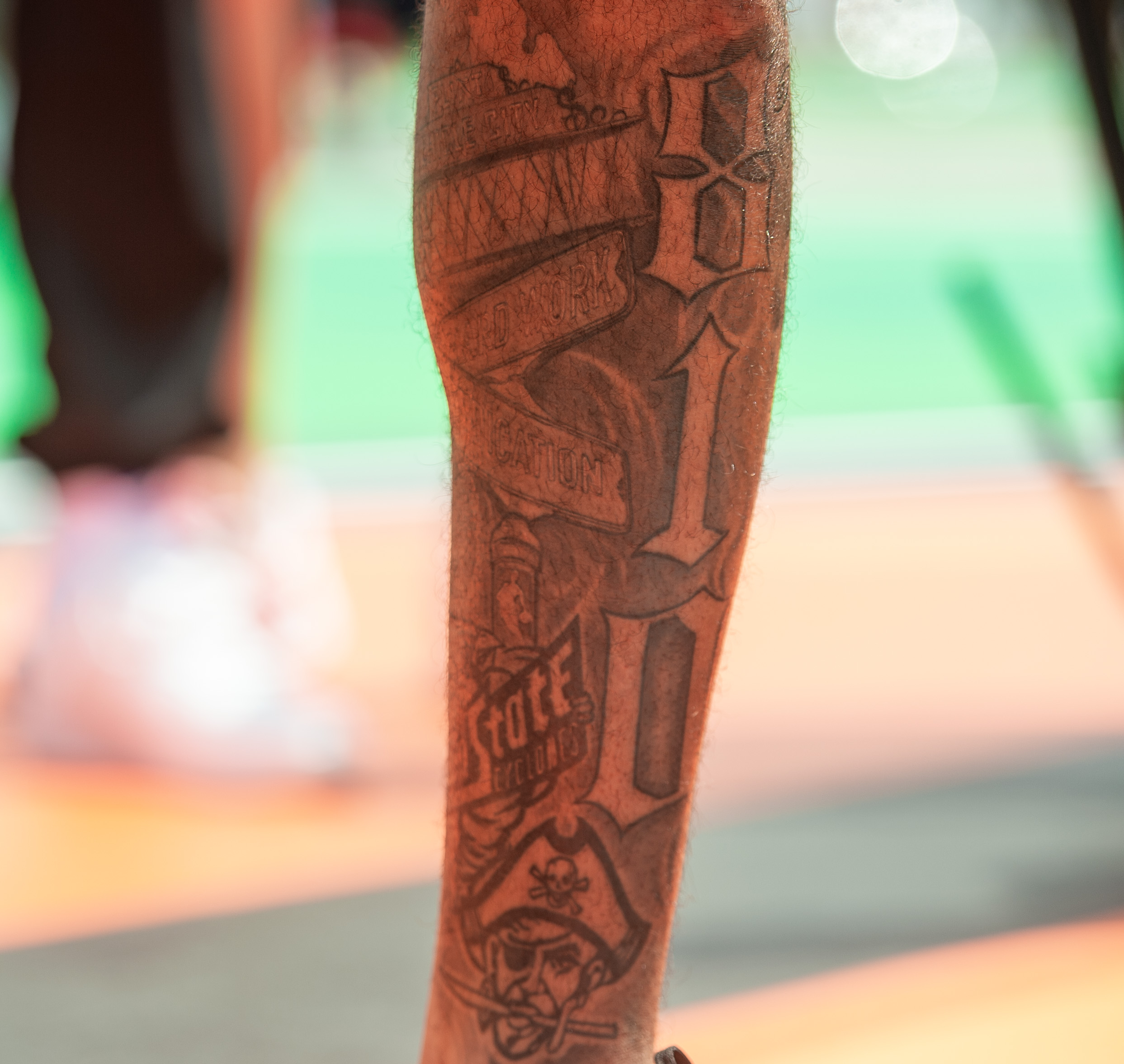 Handsome caucasian basketball player with cool tattoos standing on the court  throwing the ball up Stock Photo | Adobe Stock