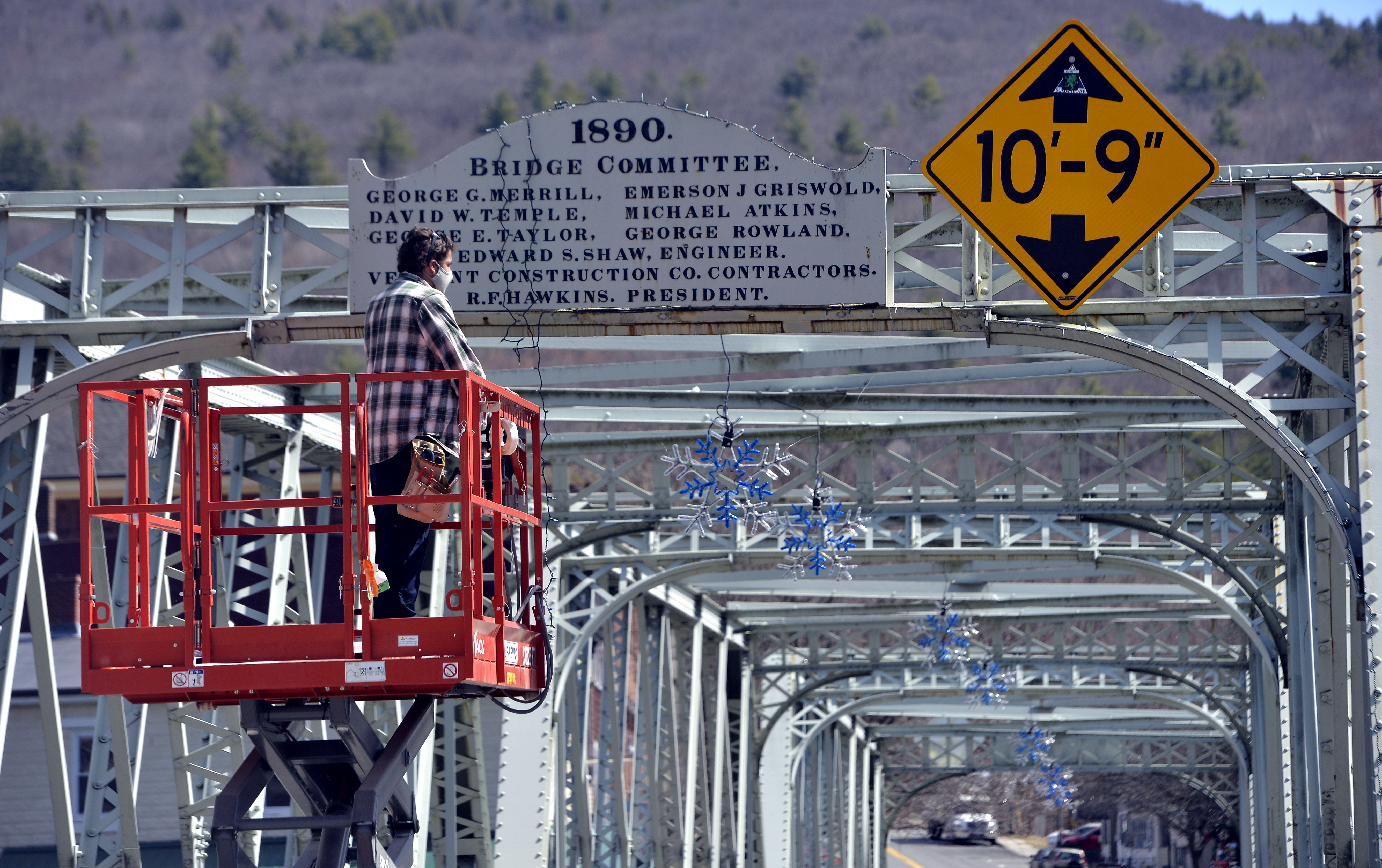 Christmas Lights are being hung on the iron bridge between downtown Shelburne Falls and Buckland as the town transforms into a winter scene for the filming of the show Dexter, April 7, 2021.   (Don Treeger / The Republican)