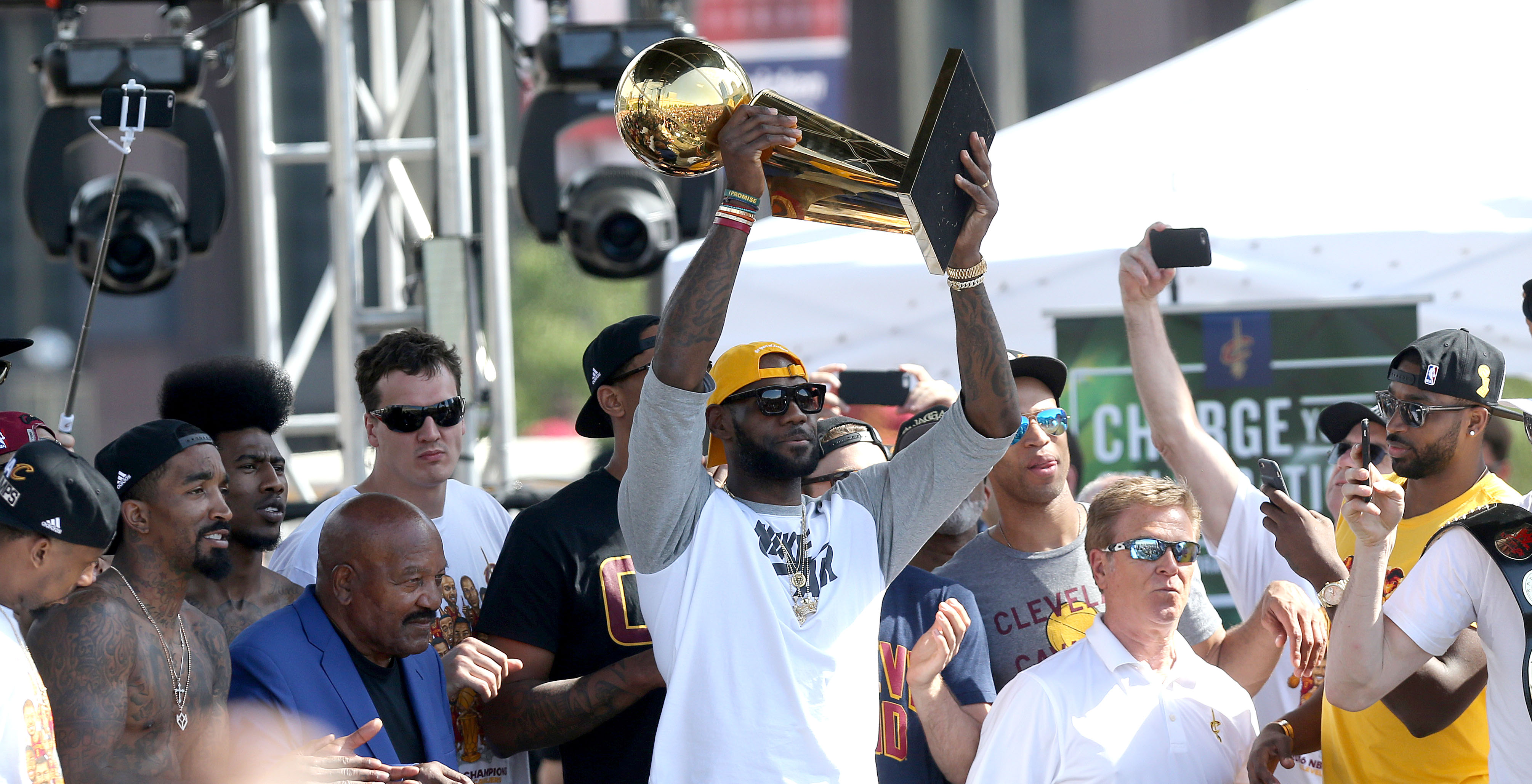 Cleveland Cavaliers forward LeBron James hoists the  Larry O'Brien trophy into the air after having it handed to him by Jim Brown at a rally to celebrate and honor the 2016 NBA Champion Cleveland Cavaliers.    Joshua Gunter, cleveland.com June 22, 2016. Cleveland. 