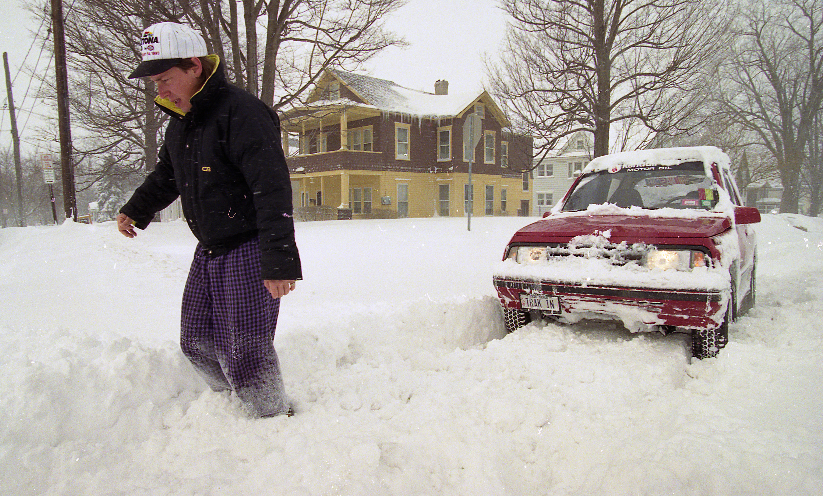 Jeff Hunter kicks snow to get through at Court and Second North Streets in  Syracuse to get his four-wheel drive truck out following the Blizzard of 1993.