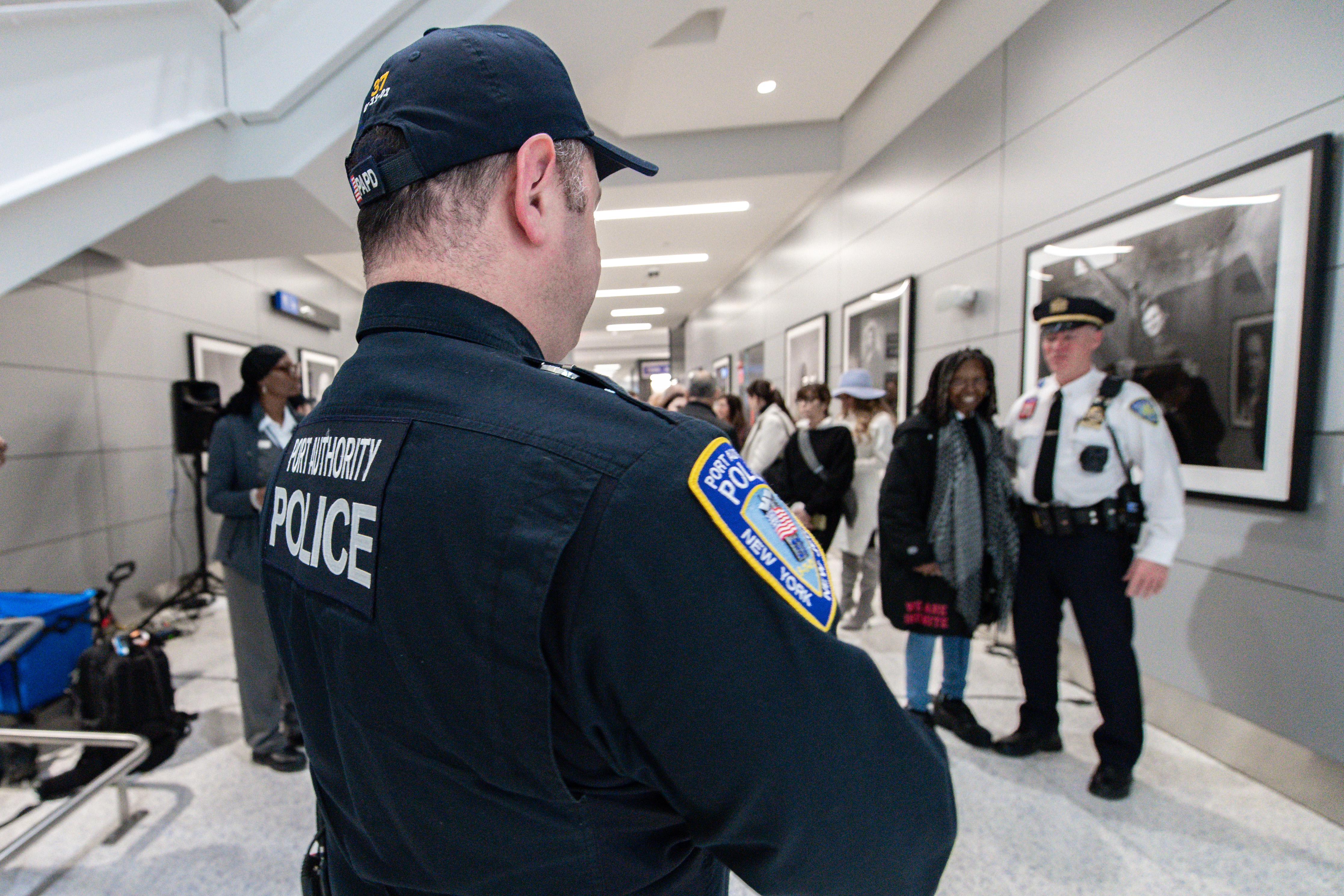 A Port Authority police officer takes a photo with Whoopi Goldberg at the opening of a photo exhibit called "What Exit: The Spirit of New Jersey: Photographs by Timothy White”, at Newark Liberty International Airport. Saturday, January 17, 2026