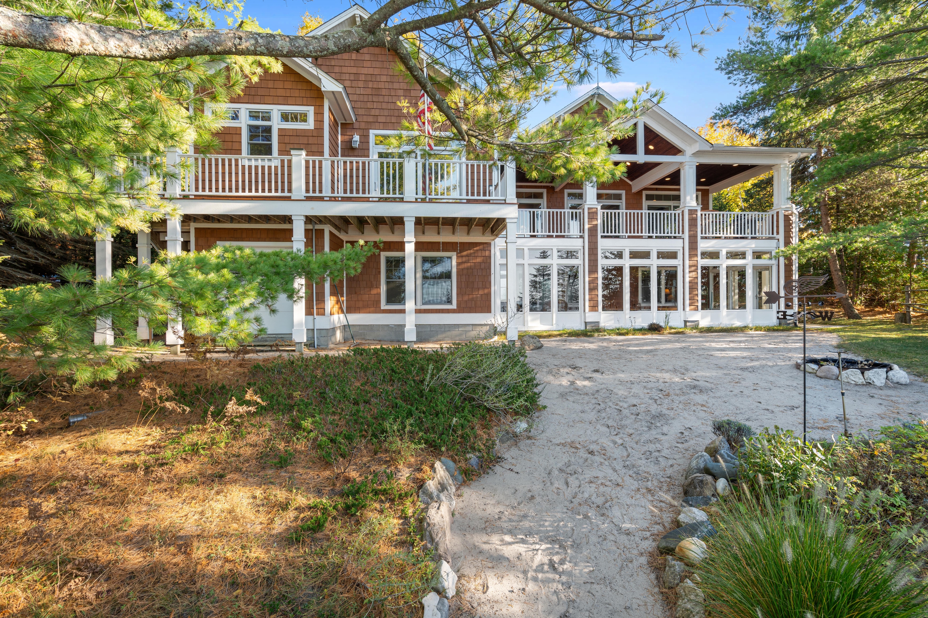 Exterior photographs of 4093 Lake Shore Drive in Charlevoix, this gem is listed at $2,099,900 through Berkshire Hathaway HomeServices Michigan Real Estate – Traverse City and The Crane Group with associate broker Johnny Crane and his brother, co-listing agent Matt Crane.