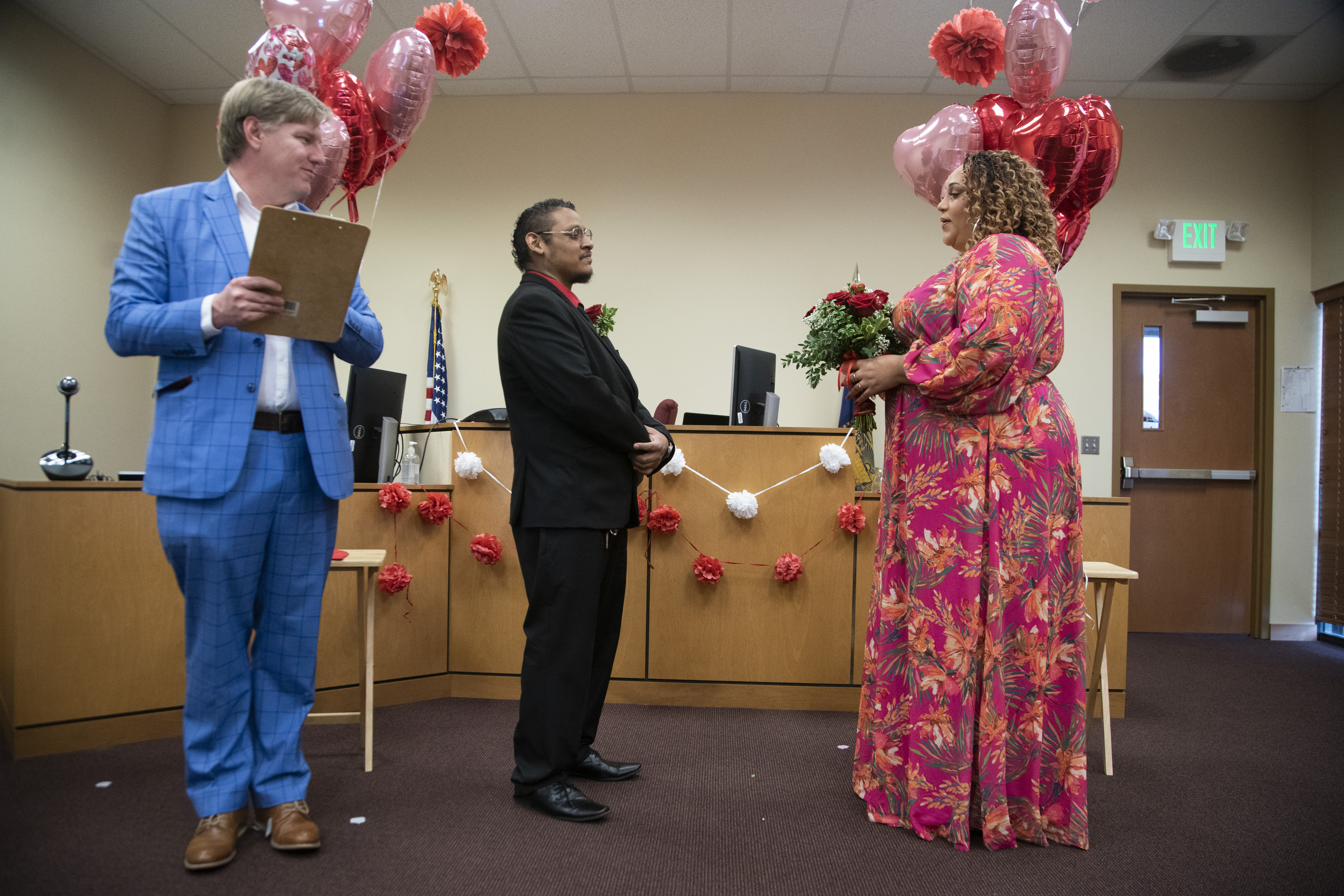 Giovani Emmanuel and Sarah Smith were married by Justice of the Peace Justin Kidd, left, at the Marion County Justice Court in Salem, February 14, 2023. Beth Nakamura/The Oregonian