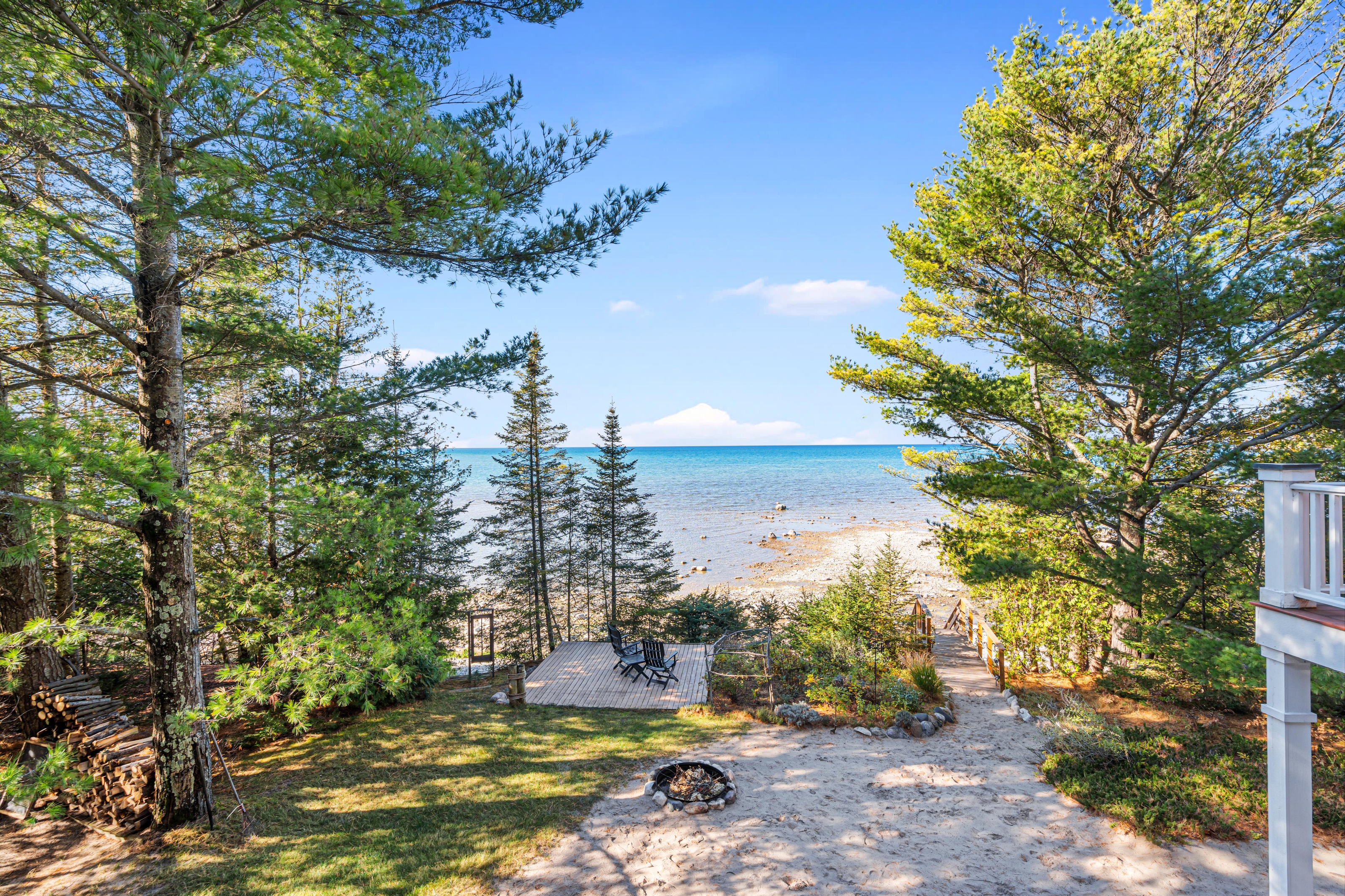 Exterior photographs of 4093 Lake Shore Drive in Charlevoix, this gem is listed at $2,099,900 through Berkshire Hathaway HomeServices Michigan Real Estate – Traverse City and The Crane Group with associate broker Johnny Crane and his brother, co-listing agent Matt Crane.