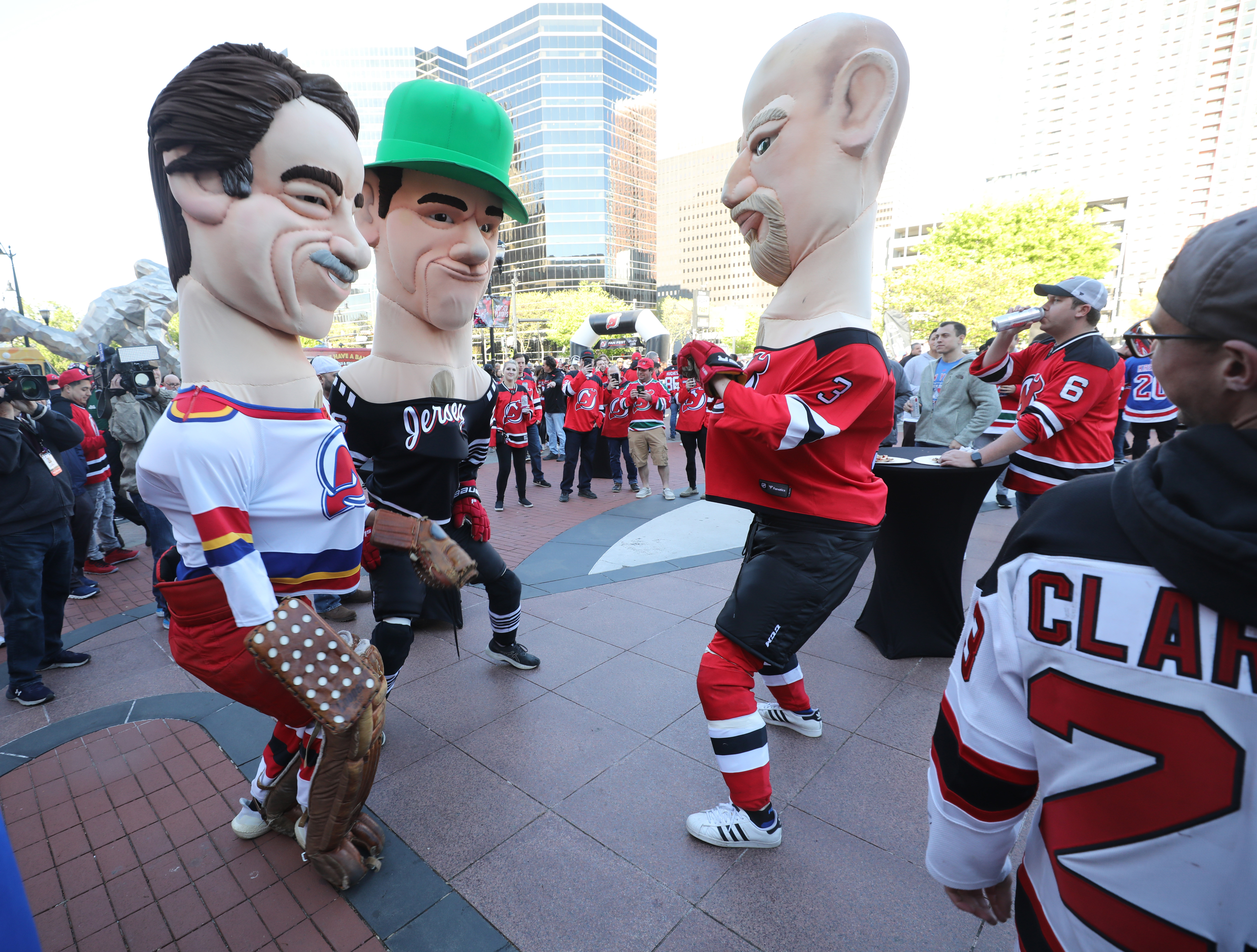 Three giant caricatures of former New Jersey Devils players (l to r) Chico Resch, Patrik Elias and Ken Daneyko dance outside Prudential Center on Tuesday, April 18, 2023 in Newark, N.J. The Devils lost to the New York Rangers, 5-1, in Game 1 of the NHL Stanley Cup playoffs.