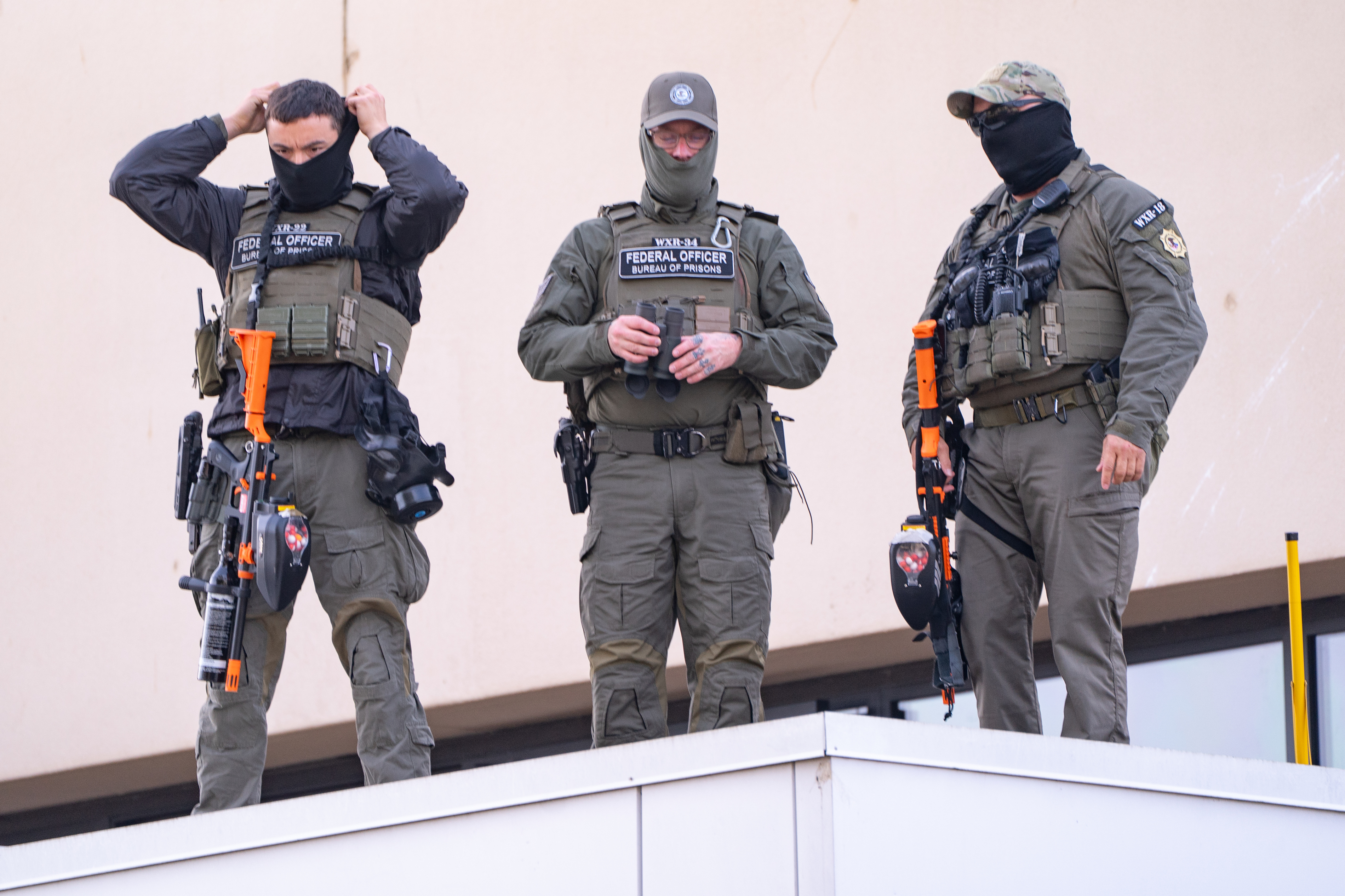 Officers on a rooftop across the street observed the “Sweatin’ Out the Fascists” ’80s-aerobics protest outside the U.S. Immigration and Customs Enforcement (ICE) facility in South Portland on Sunday, Nov. 9, 2025.
