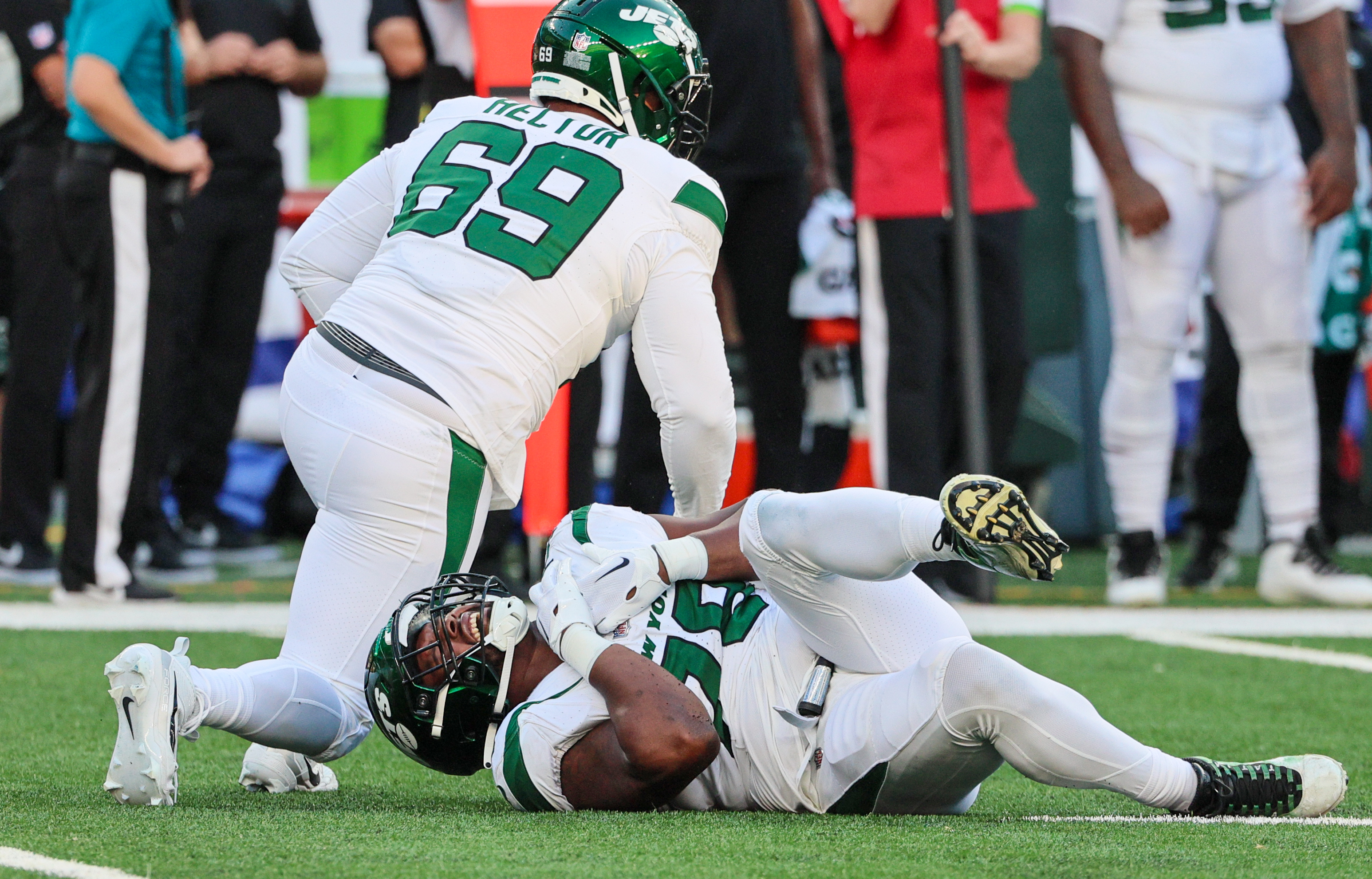 New York Jets offensive tackle Mekhi Becton (77) hugs quarterback Aaron  Rodgers (8) during an NFL football game against the New York Giants,  Saturday, Aug. 26, 2023 in East Rutherford, N.J. Jets