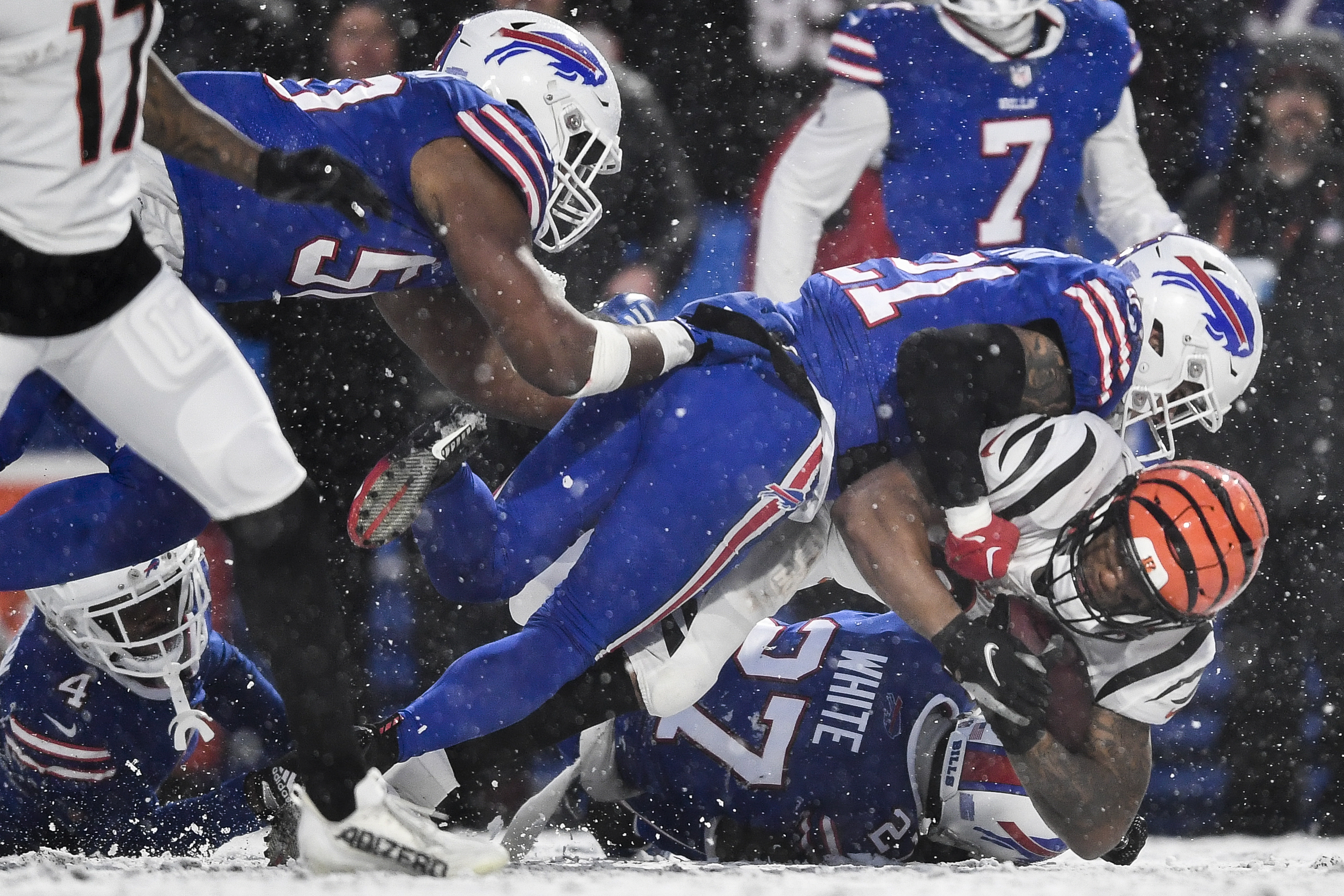 Cincinnati Bengals running back Joe Mixon (28) is tackled by the Buffalo  Bills during the first quarter of an NFL division round football game,  Sunday, Jan. 22, 2023, in Orchard Park, N.Y. (