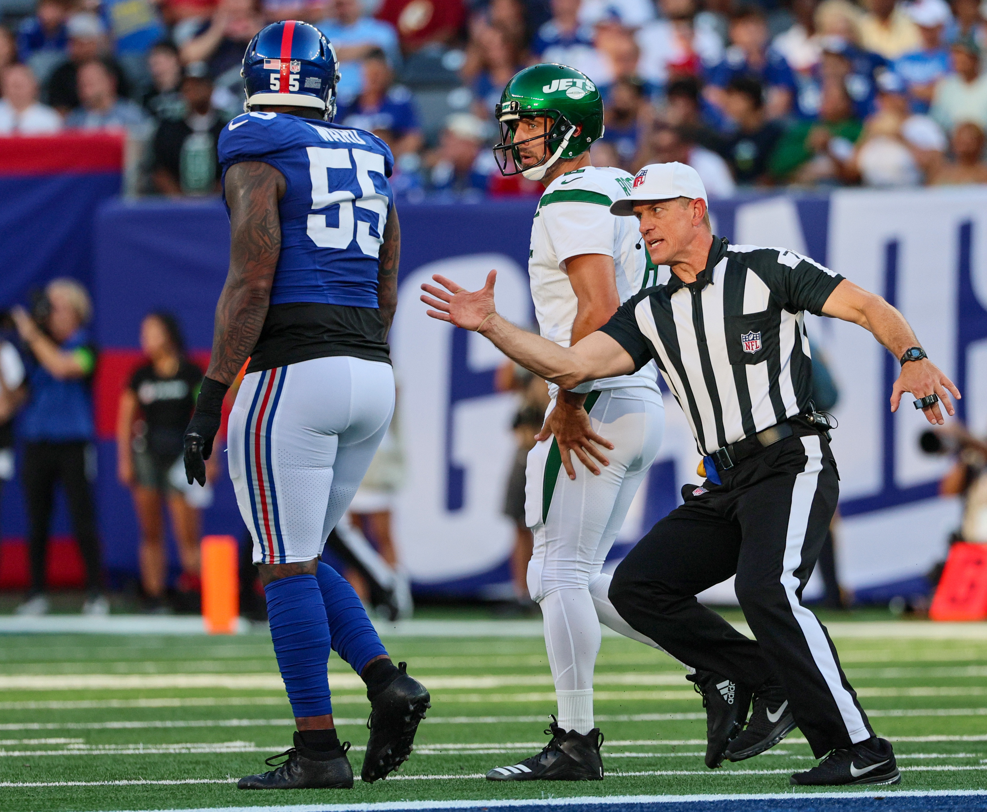 New York Jets offensive tackle Mekhi Becton (77) hugs quarterback Aaron  Rodgers (8) during an NFL football game against the New York Giants,  Saturday, Aug. 26, 2023 in East Rutherford, N.J. Jets