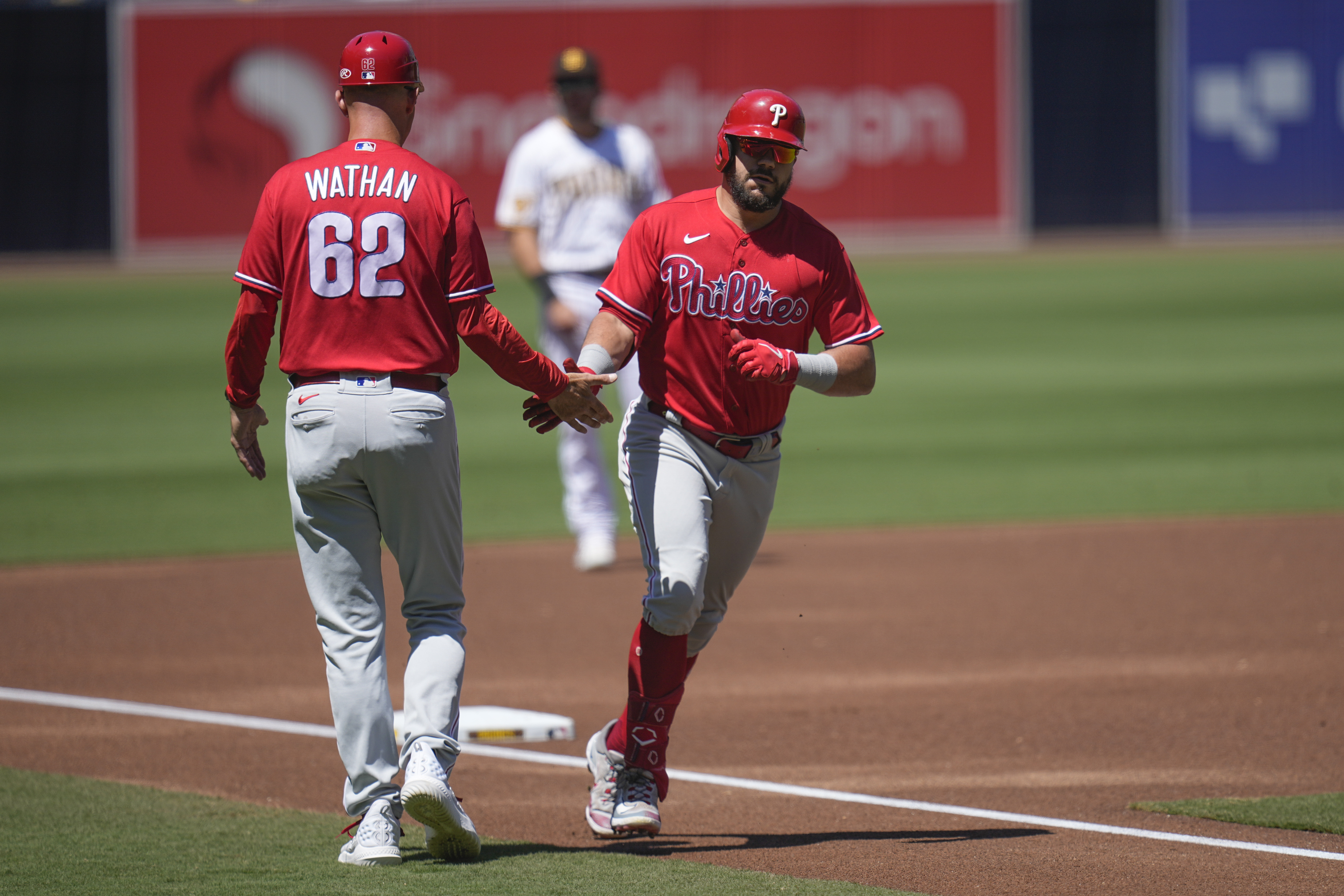 San Diego Padres' Garrett Cooper, right, celebrates with third