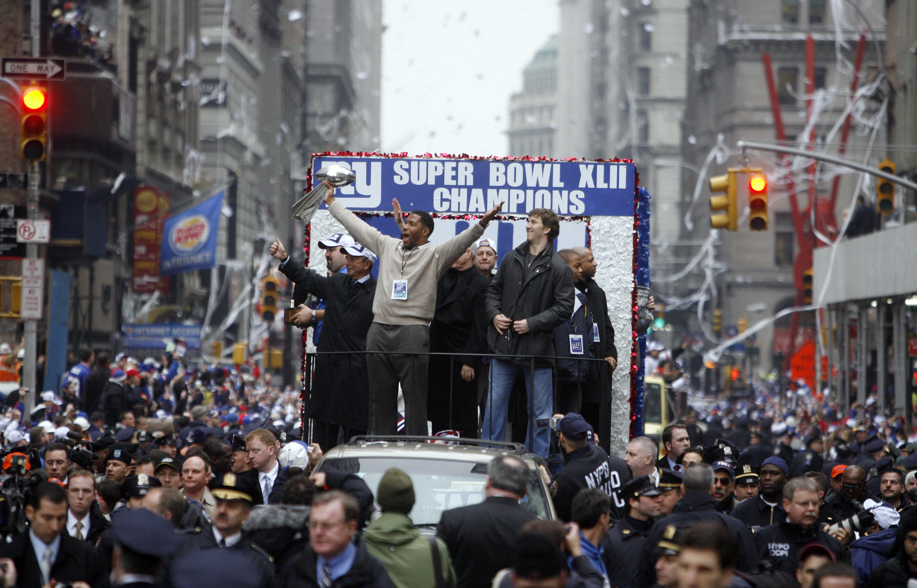 Michael Strahan (left) and Eli Manning celebrate with the Vince Lombardi Trophy as New York City celebrates the New York Giants win in Super Bowl XLII with a ticker tape parade up  Broadway. MANHATTAN, NYC (2008 file photo by Andrew Mills | The Star-Ledger)