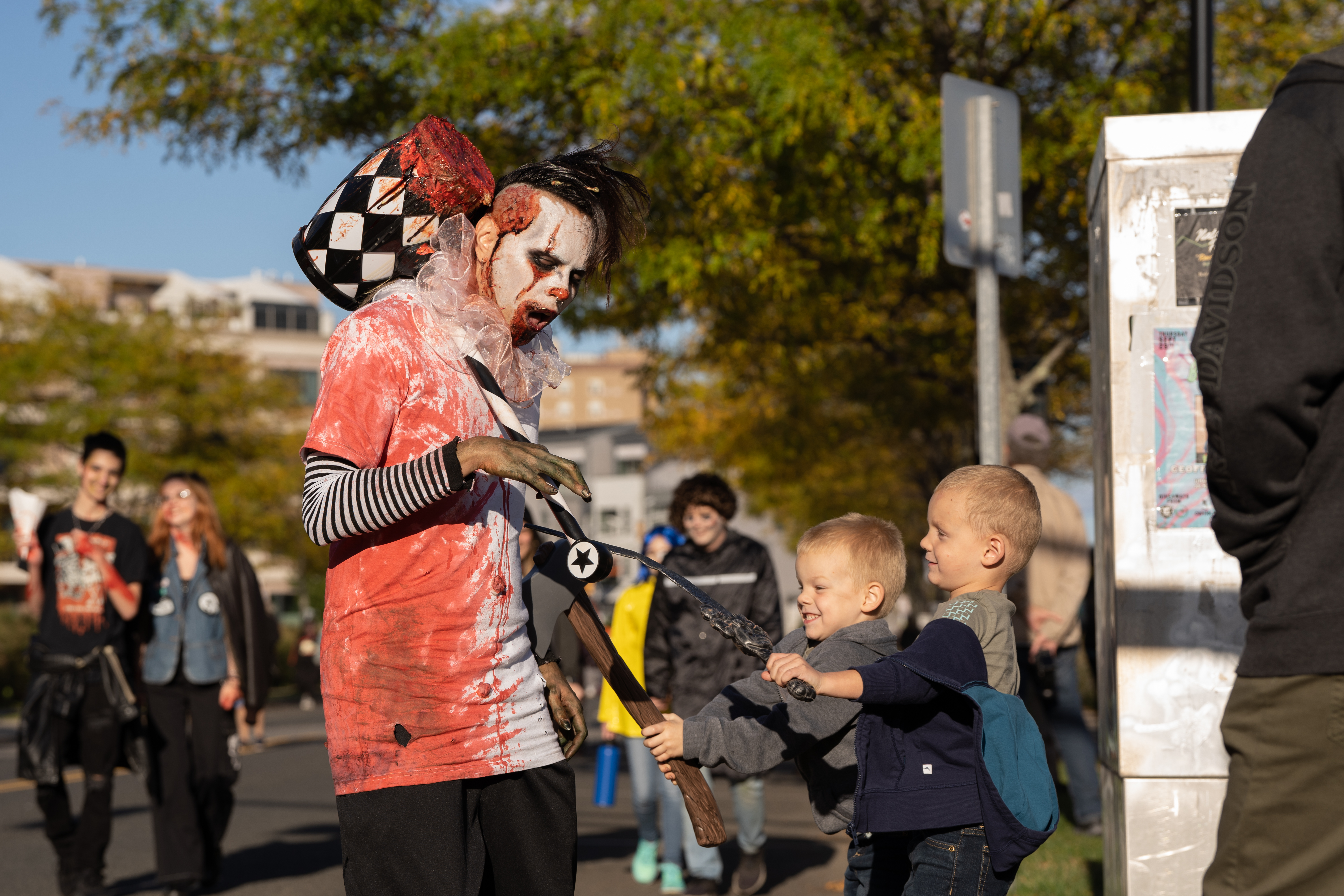 Two children defend themselves from a zombie during the 14th Asbury Park Zombie Walk in Asbury Park on Saturday, October 8, 2022. The zombie walk held its first themed year with the theme being 80's and 90's punk and metal.