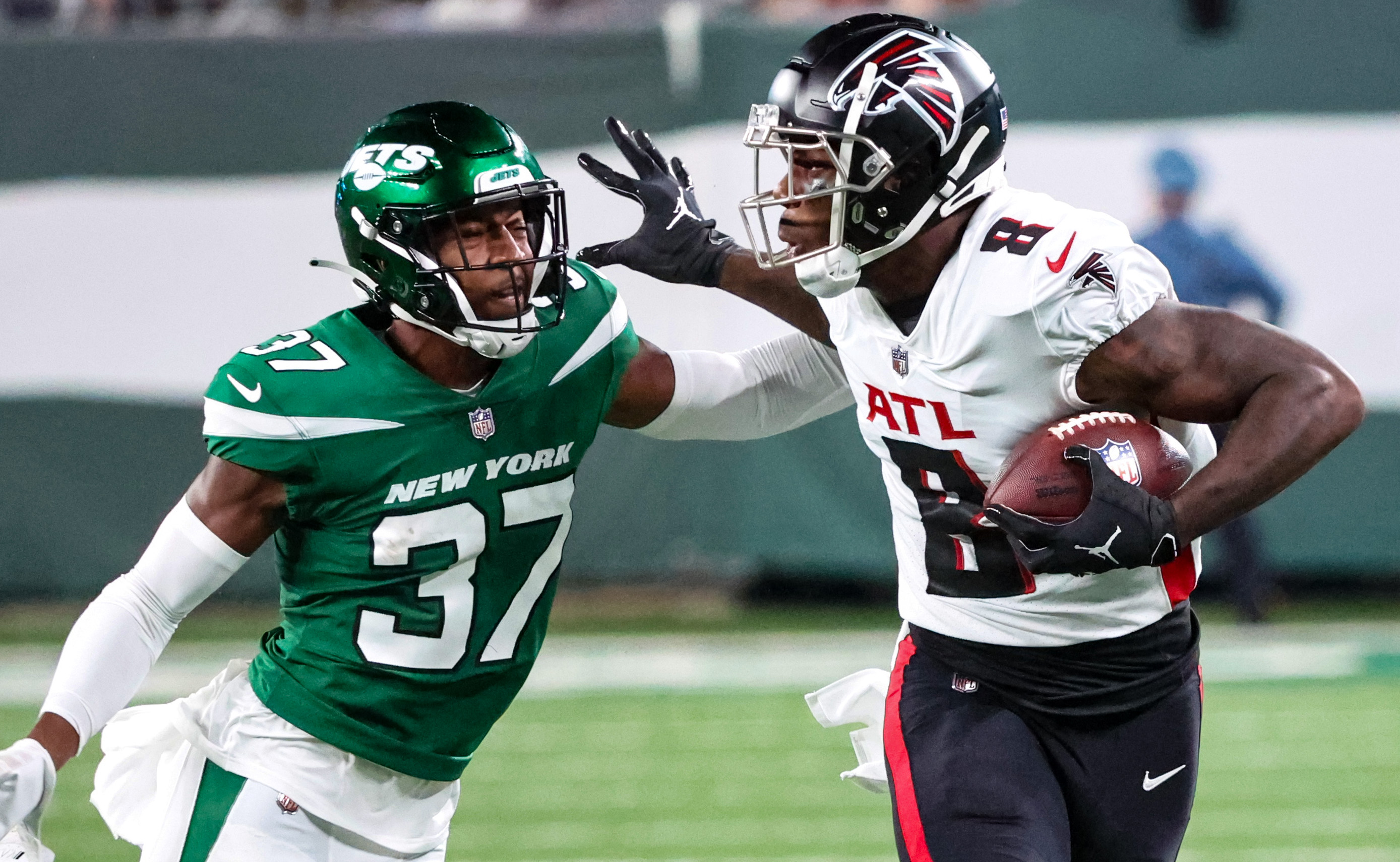 Atlanta Falcons tight end Kyle Pitts (8) walks the field wearing