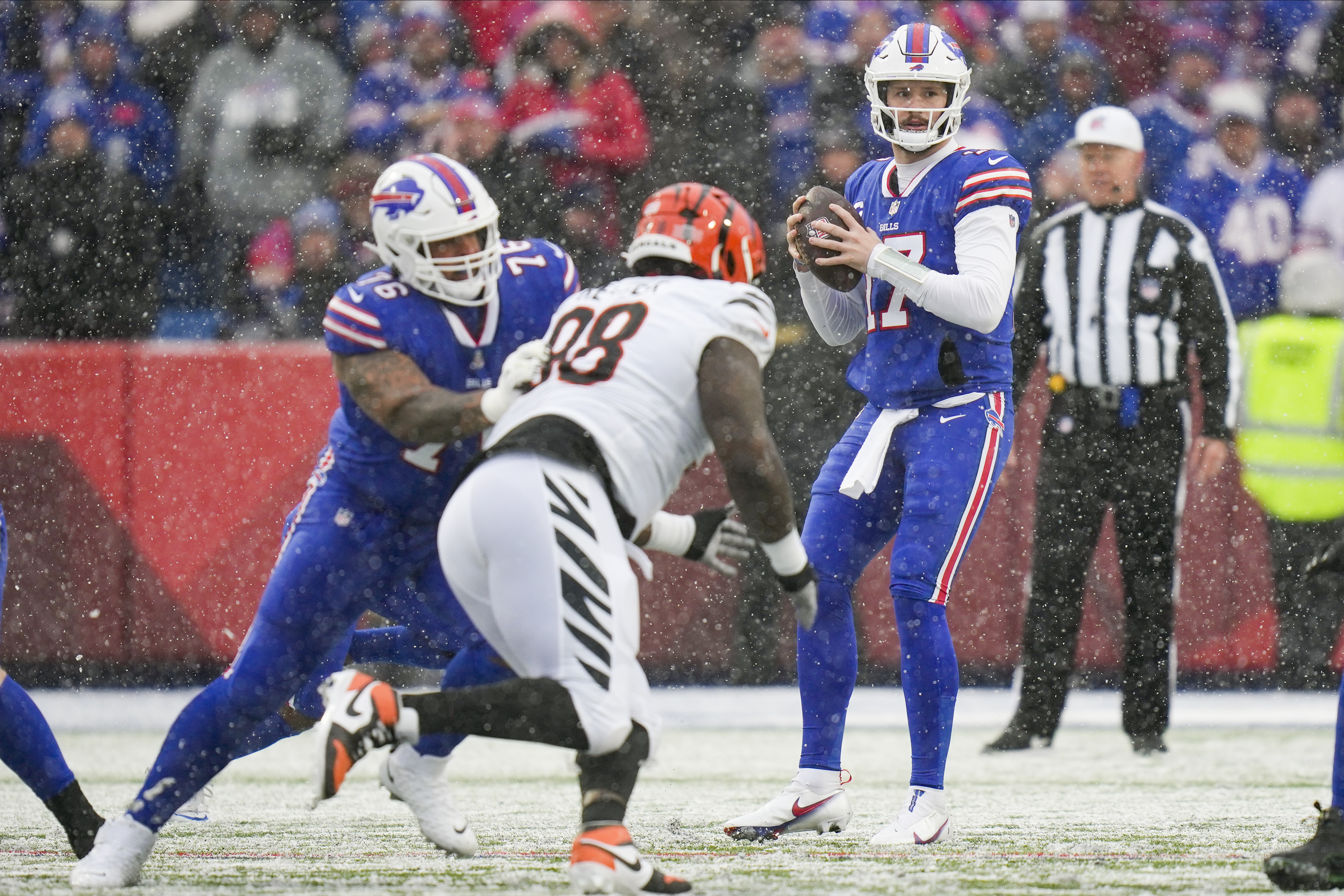 Cincinnati Bengals running back Joe Mixon (28) is tackled by the Buffalo  Bills during the first quarter of an NFL division round football game,  Sunday, Jan. 22, 2023, in Orchard Park, N.Y. (