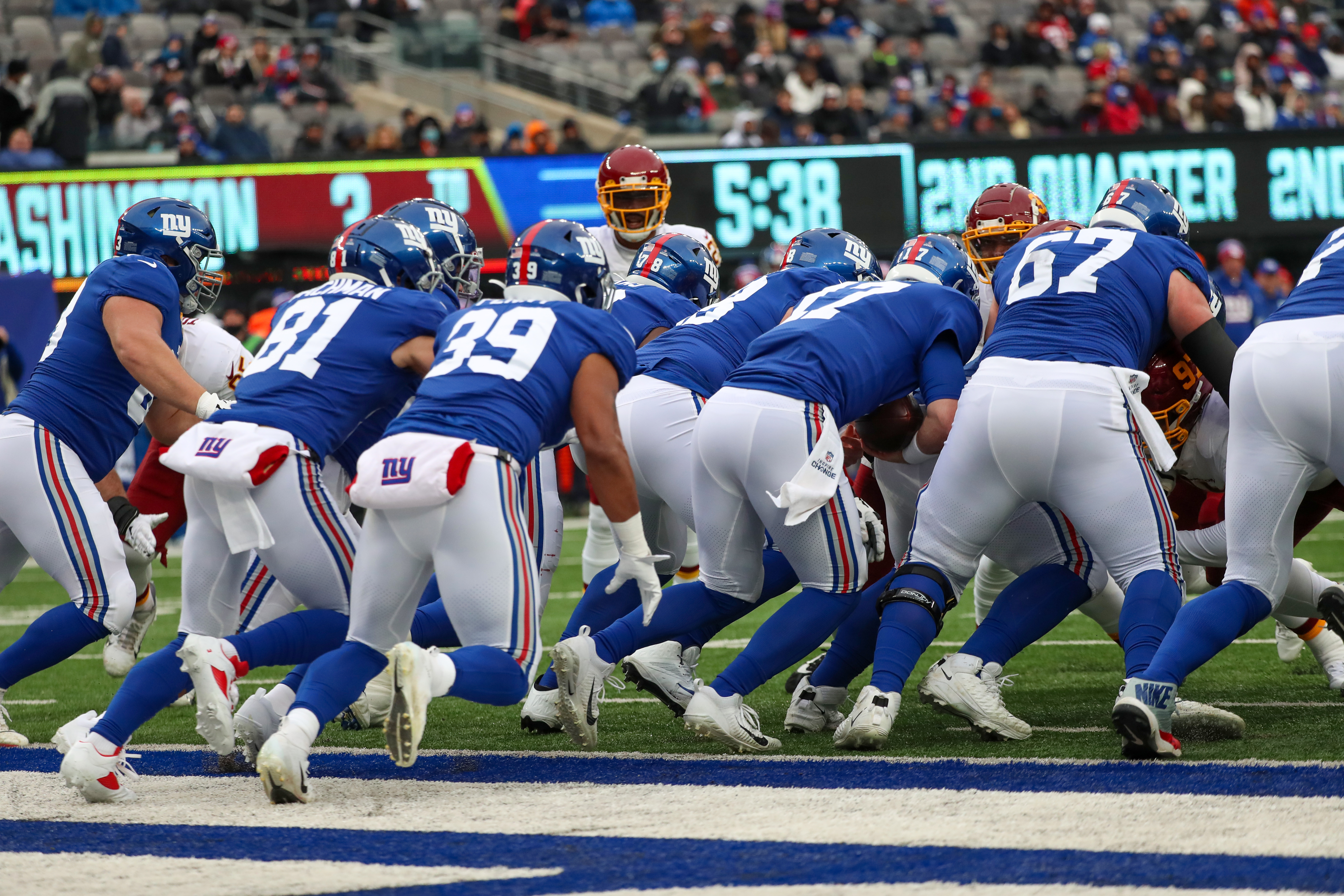 The New York Giants offense lines up in a victory formation of sorts as quarterback Jake Fromm (17) runs the ball into the line of scrimmage against the Washington Football Team during the second quarter on Sunday, Jan. 9, 2022 in East Rutherford, N.J. Washington won, 22-7.