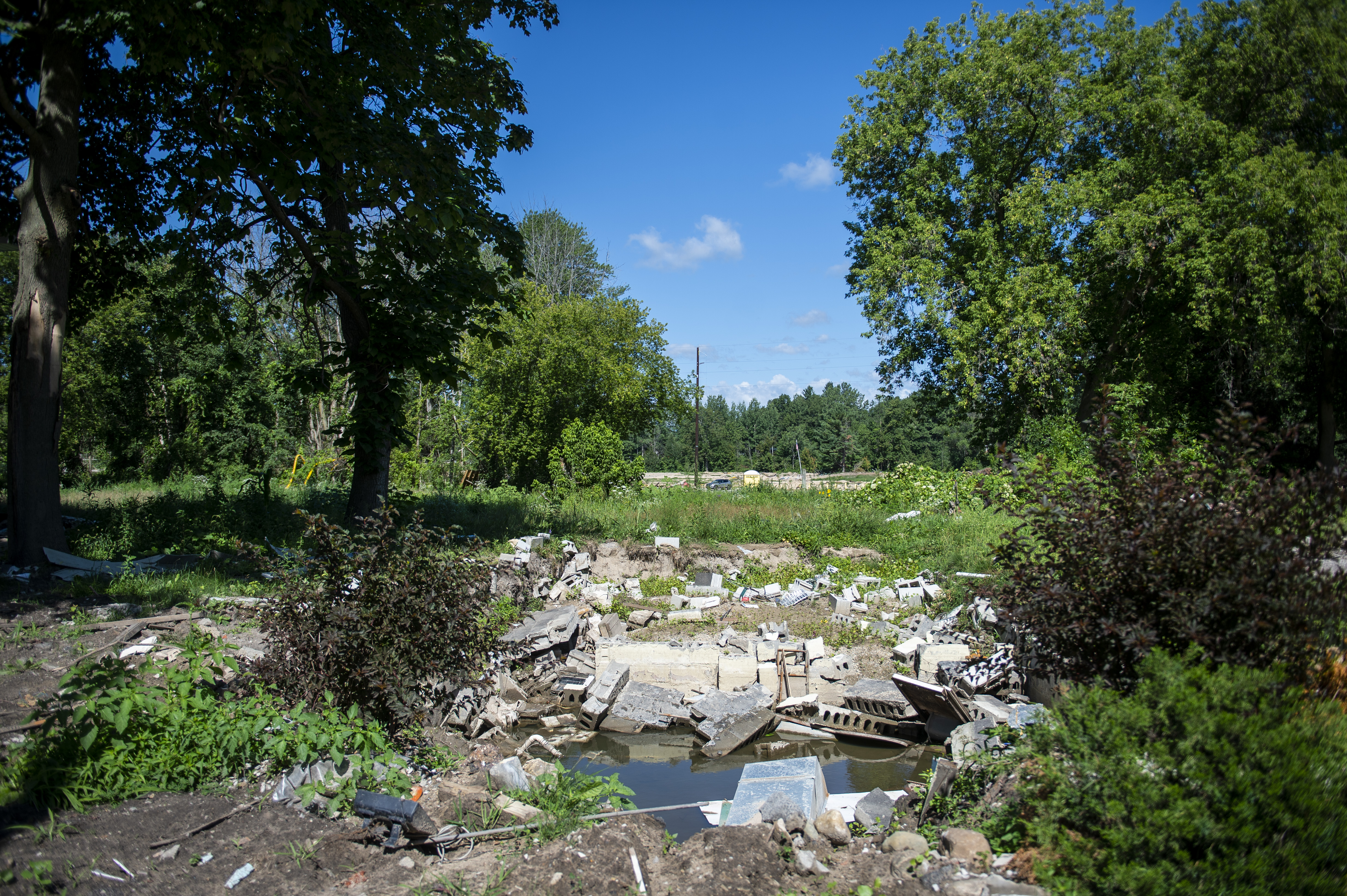 A view of what's left of a foundation of a home near the Sanford Dam in Sanford on Thursday, July 30, 2020. The devastating flood in May gushed over the majority of land in this area. (Kaytie Boomer | MLive.com)