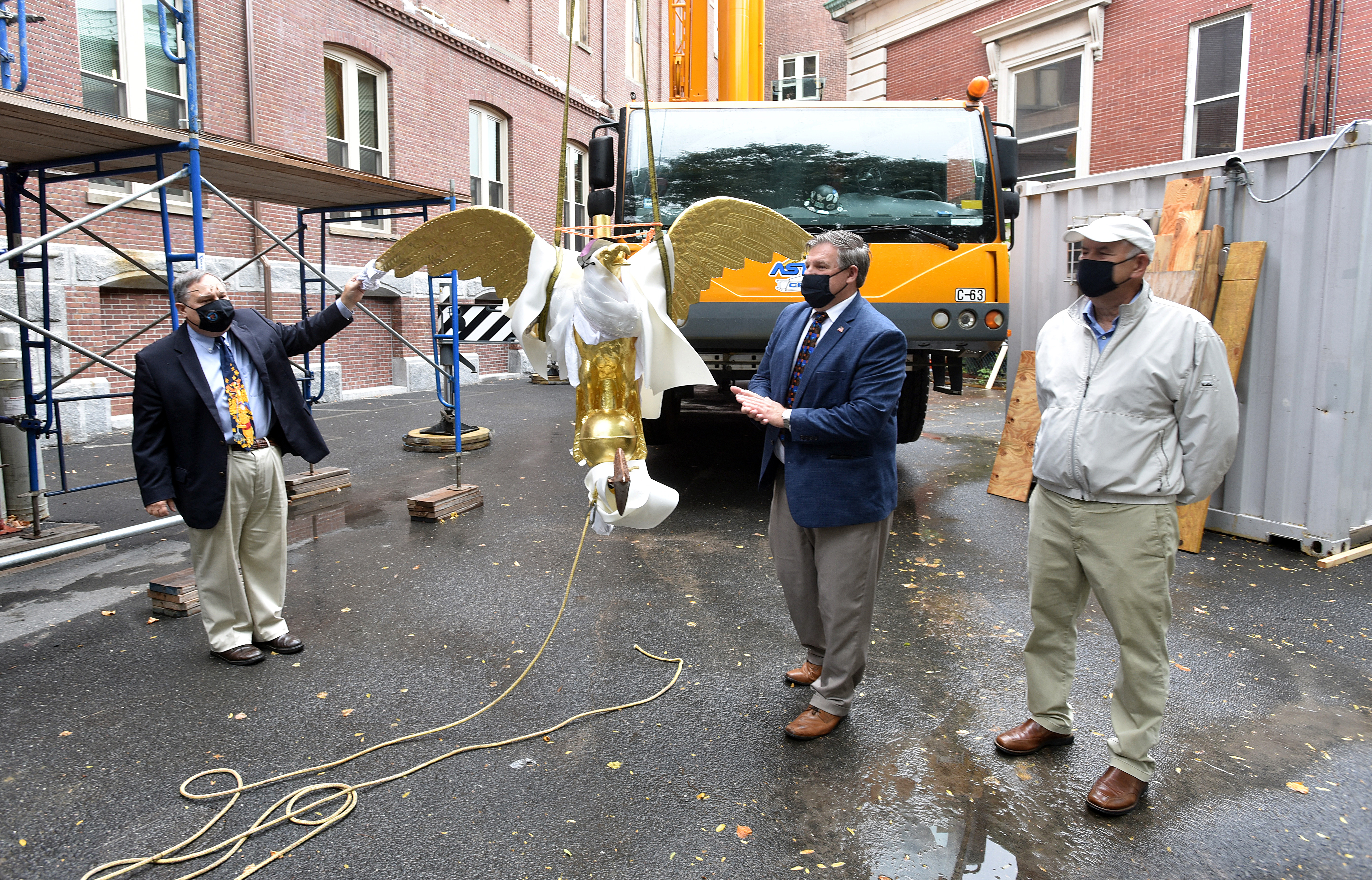 10/6/2020 -Chicopee-  Chicopee Mayor John Vieau speaks next to a replica of  the "Chicopee Eagle Weathervane" before it was placed on top of the City Hall Clock Tower, now undergoing renovations. The original eagle will be on display in the City Hall auditorium once building renovations are complete. On the left is mayoral chief of staff Michael Pise and on the right is city councilor George Balakier.   (Don Treeger / The Republican)