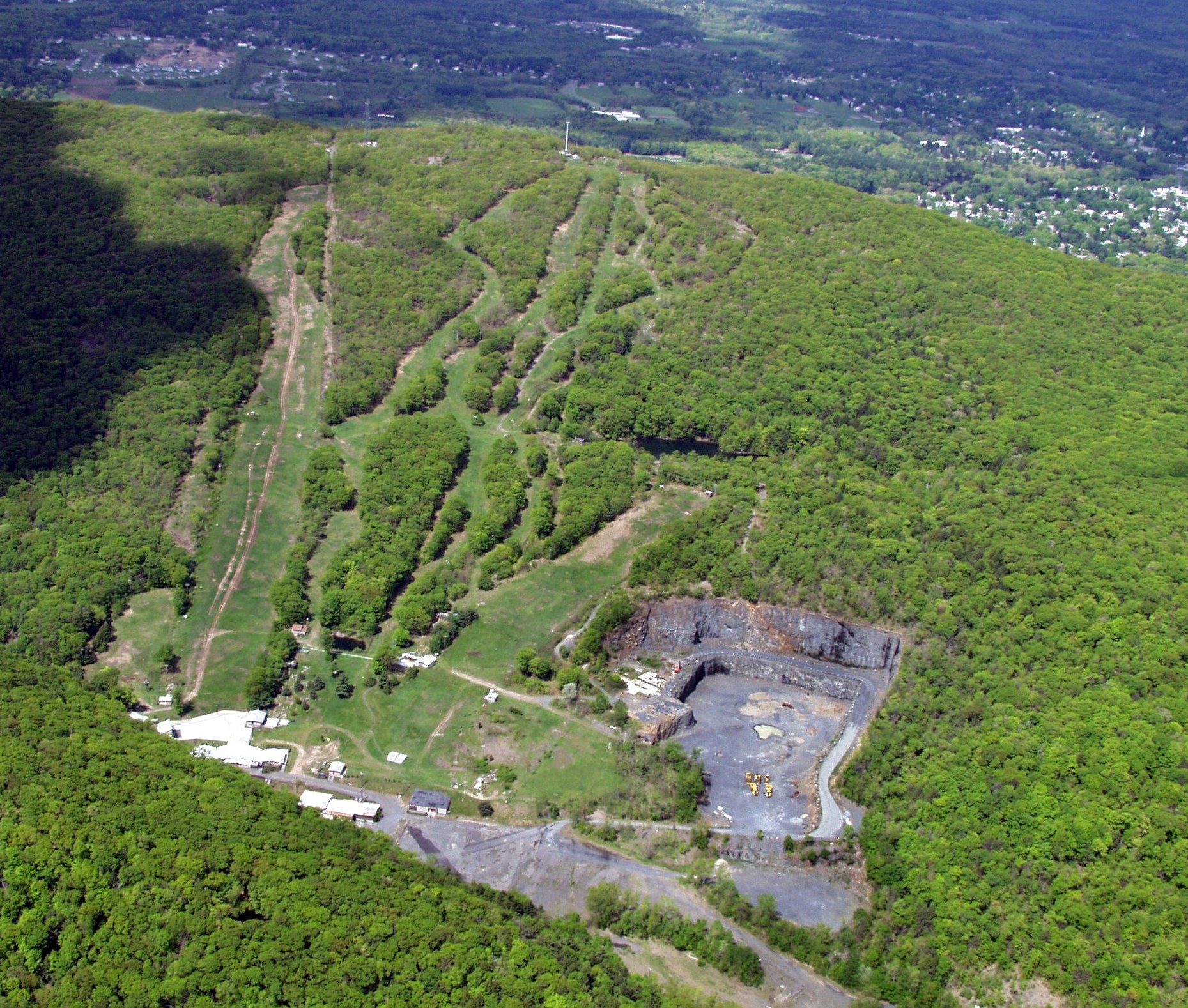 An aerial photo taken in May 2002, shows the sinuous trails of the former Mount Tom Ski Area, visible four years after the Holyoke area closed. At lower right is the Mount Tom Quarry.