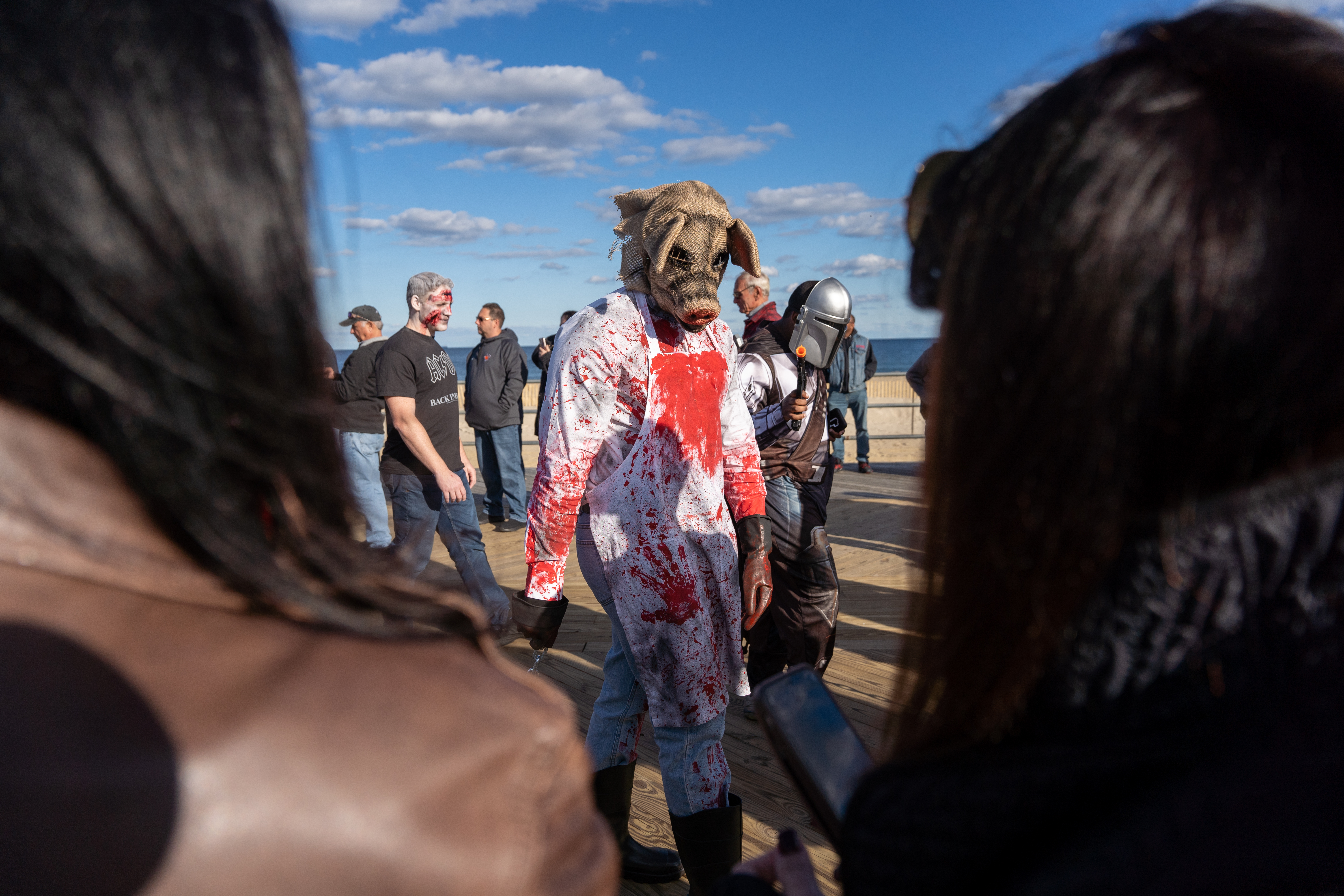 A zombie pig butcher stares down the crowd as they participate in the 14th Asbury Park Zombie Walk in Asbury Park on Saturday, October 8, 2022. The zombie walk held its first themed year with the theme being 80's and 90's punk and metal.