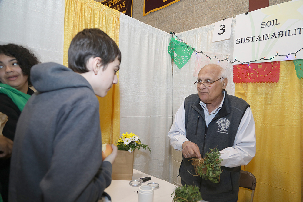 Dr. Masoud Hashemi from UMass Stockbridge at his Soil Sustainability table at the Sustainathon event taking place in the gym in building 2 at Springfield Technical Community College on April 11th. (Ed Cohen Photo)