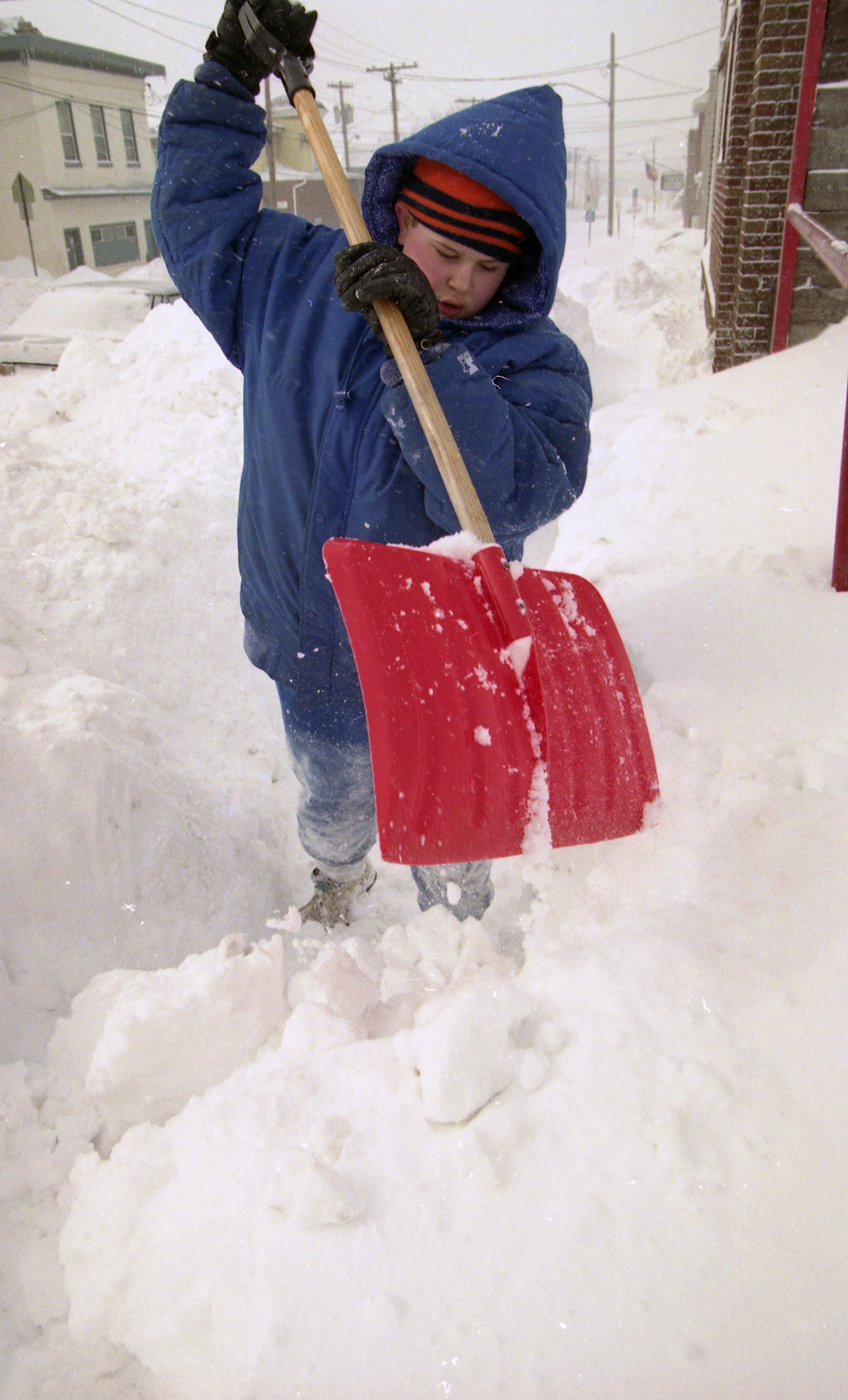 Samuel Ciciarelli, whose father is pastor of Charity Baptist Church on Butternut Street  in Syracuse, shovels off sidewalk in front of the church on March 14, 1993.