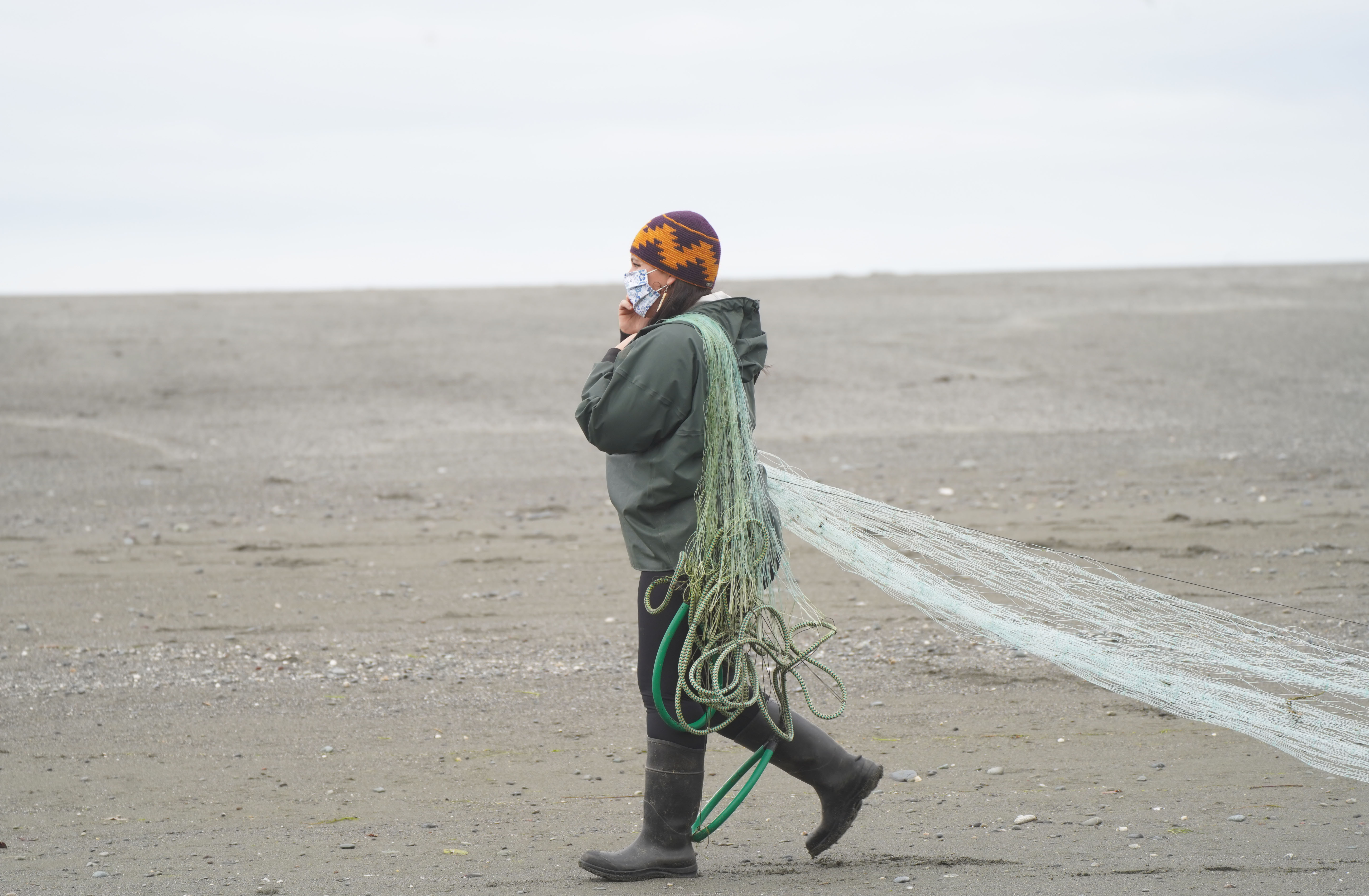A member of the Yurok Indian Tribe uses a dip net to fish for