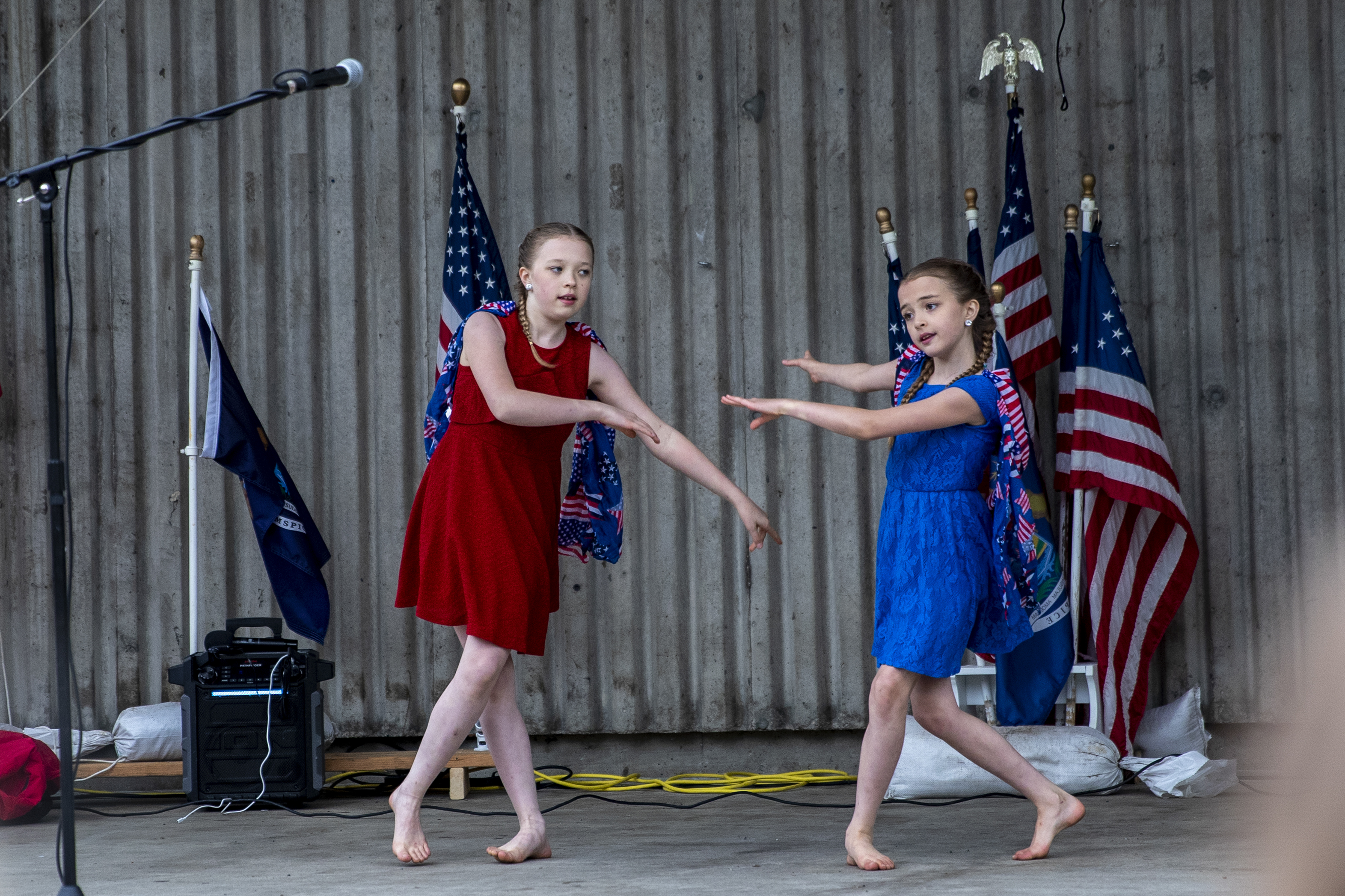 Hayden, 13, and Gracee Heikkila, 10, perform a dance routine they developed to the song "We Bleed The Same Color" by Mandisa, featuring TobyMac and Kirk Franklin, during the "American Patriot Rally-Sheriffs speak out" event at Rosa Parks Circle in downtown Grand Rapids on Monday, May 18, 2020. The crowd is protesting against Gov. Gretchen Whitmer's stay-at-home order. The sisters are from Battle Creek. (Cory Morse | MLive.com)