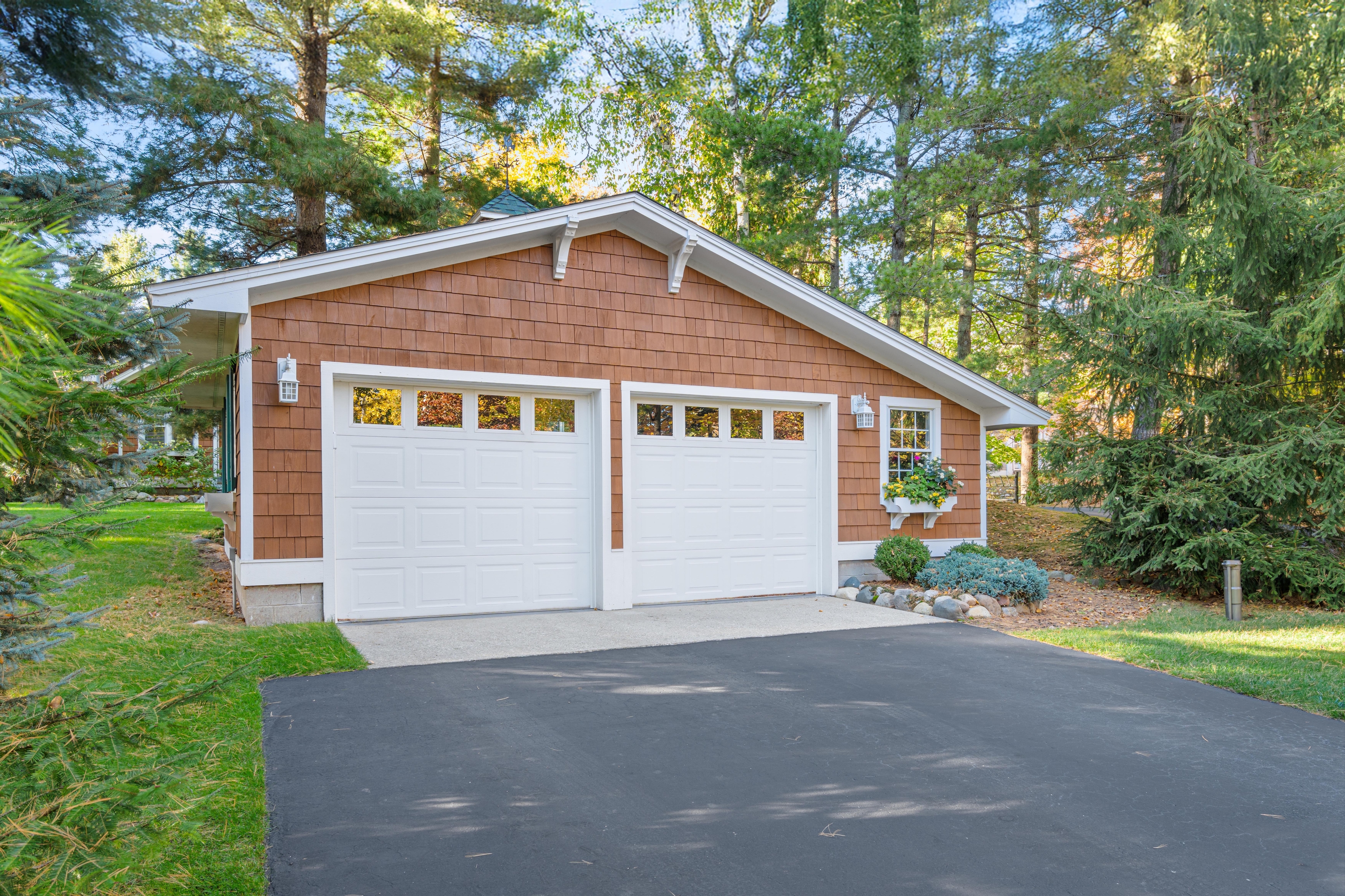 Exterior photographs of 4093 Lake Shore Drive in Charlevoix, this gem is listed at $2,099,900 through Berkshire Hathaway HomeServices Michigan Real Estate – Traverse City and The Crane Group with associate broker Johnny Crane and his brother, co-listing agent Matt Crane.