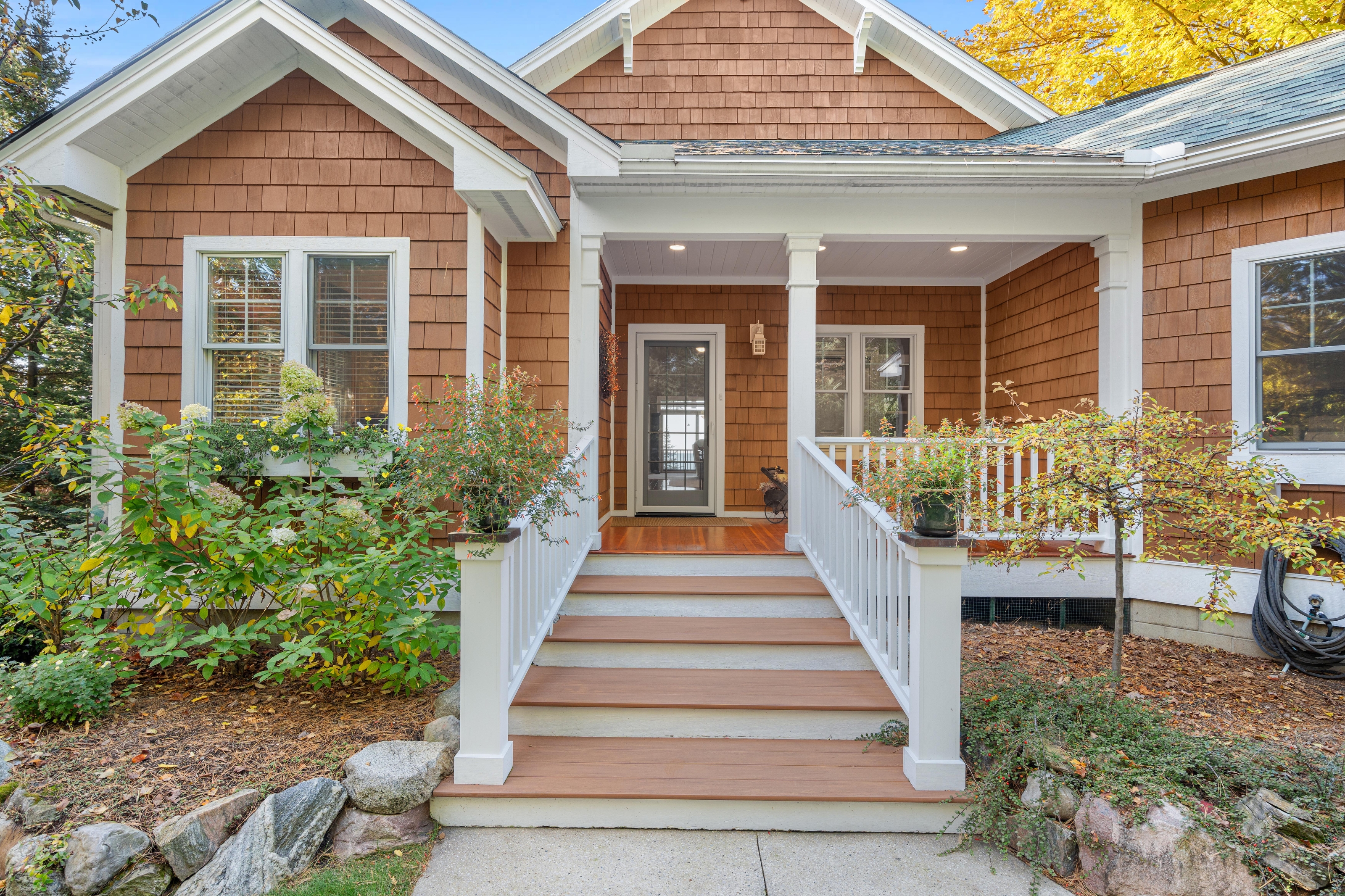 Exterior photographs of 4093 Lake Shore Drive in Charlevoix, this gem is listed at $2,099,900 through Berkshire Hathaway HomeServices Michigan Real Estate – Traverse City and The Crane Group with associate broker Johnny Crane and his brother, co-listing agent Matt Crane.