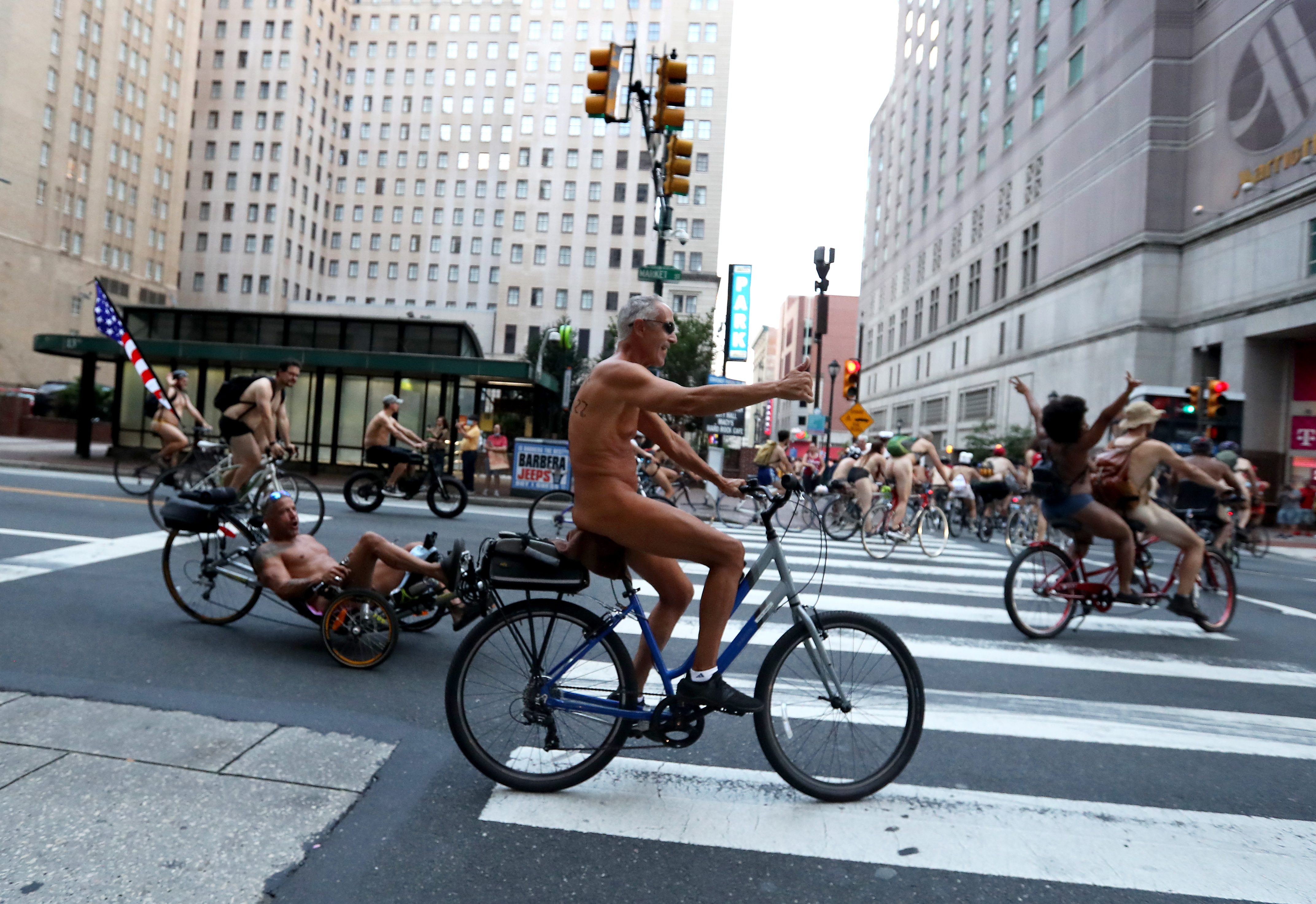 People ride bikes along Market Street in Philadelphia during the Philly Naked Bike Ride, Saturday, Aug. 27, 2022.