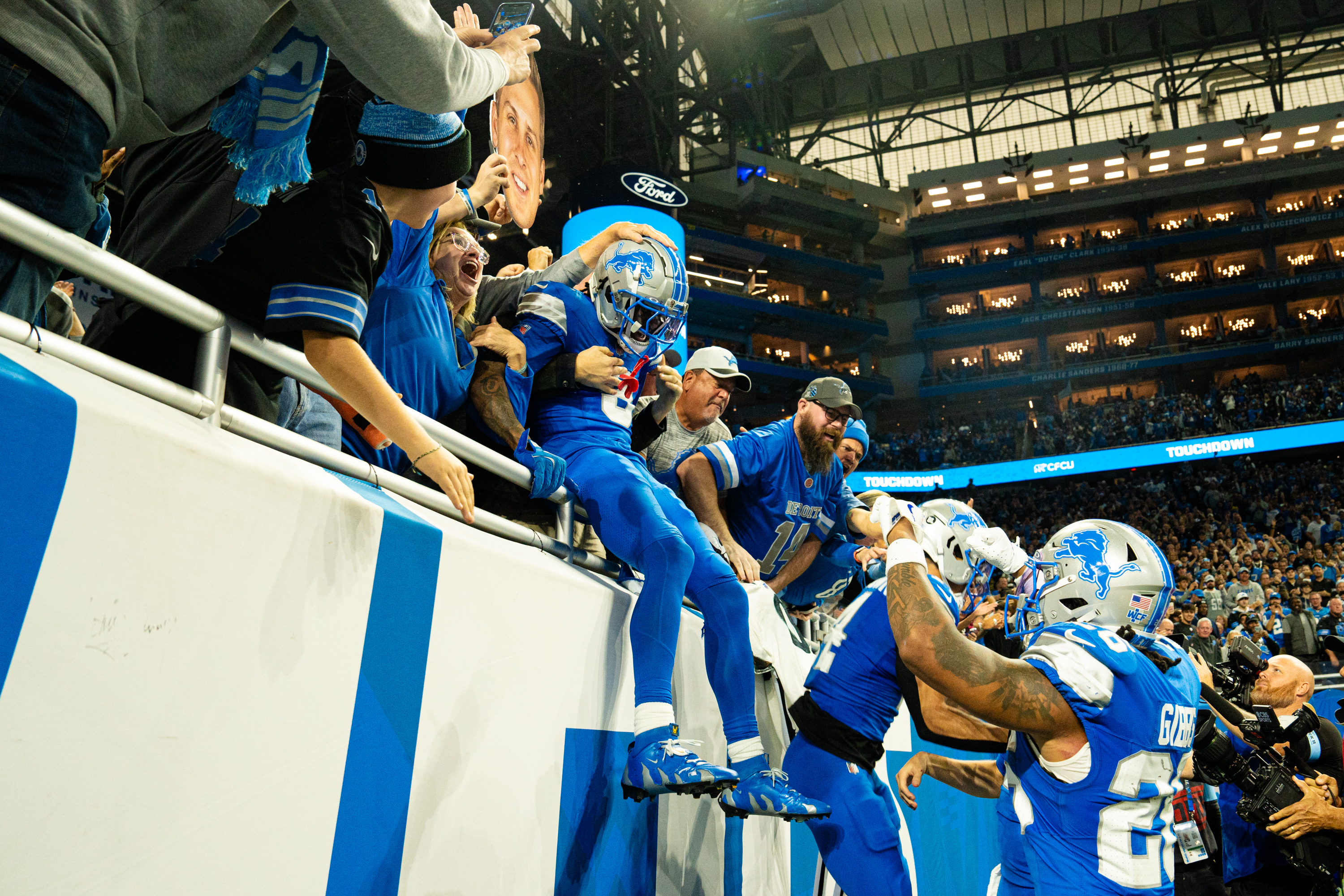 Detroit Lions running back Jahmyr Gibbs (26), Detroit Lions wide receiver Amon-Ra St. Brown (14) and Detroit Lions wide receiver Allen Robinson (8) celebrate a touchdown with fans in the stands during Detroit Lions vs Jacksonville Jaguars at Ford Field in Detroit on Sunday, Nov. 17, 2024. The Lions won 52-6.