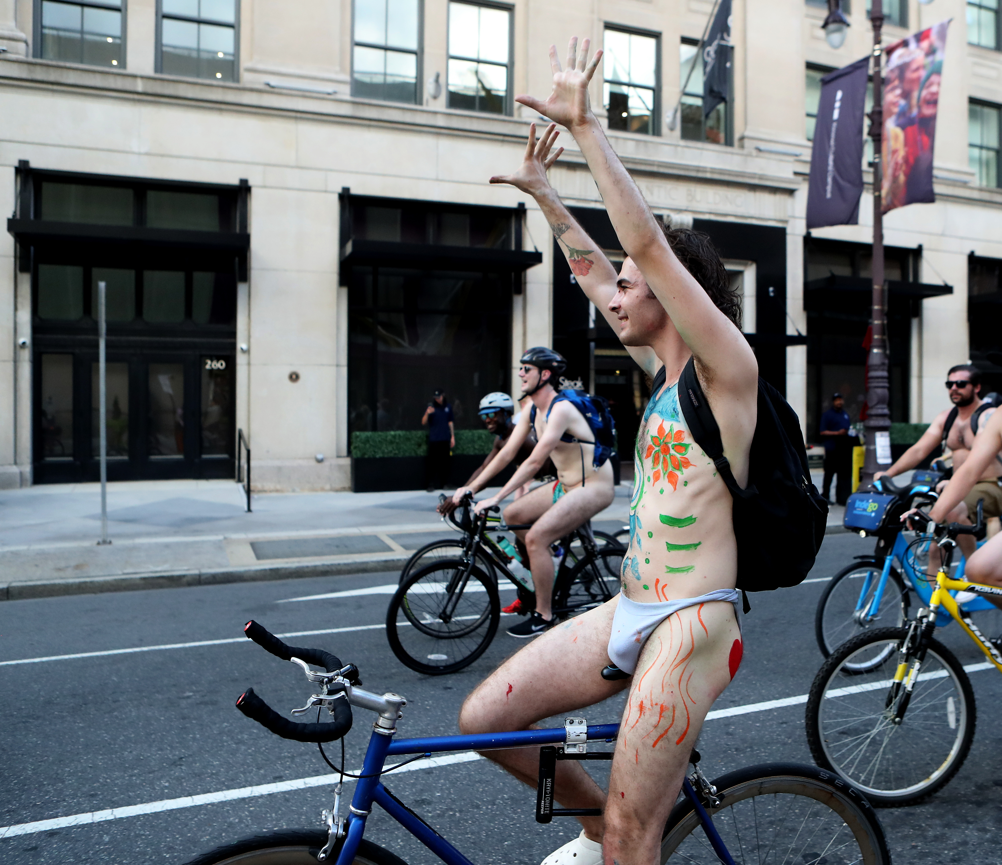 People ride bikes along South Broad Street in Philadelphia during the Philly Naked Bike Ride, Saturday, Aug. 27, 2022.