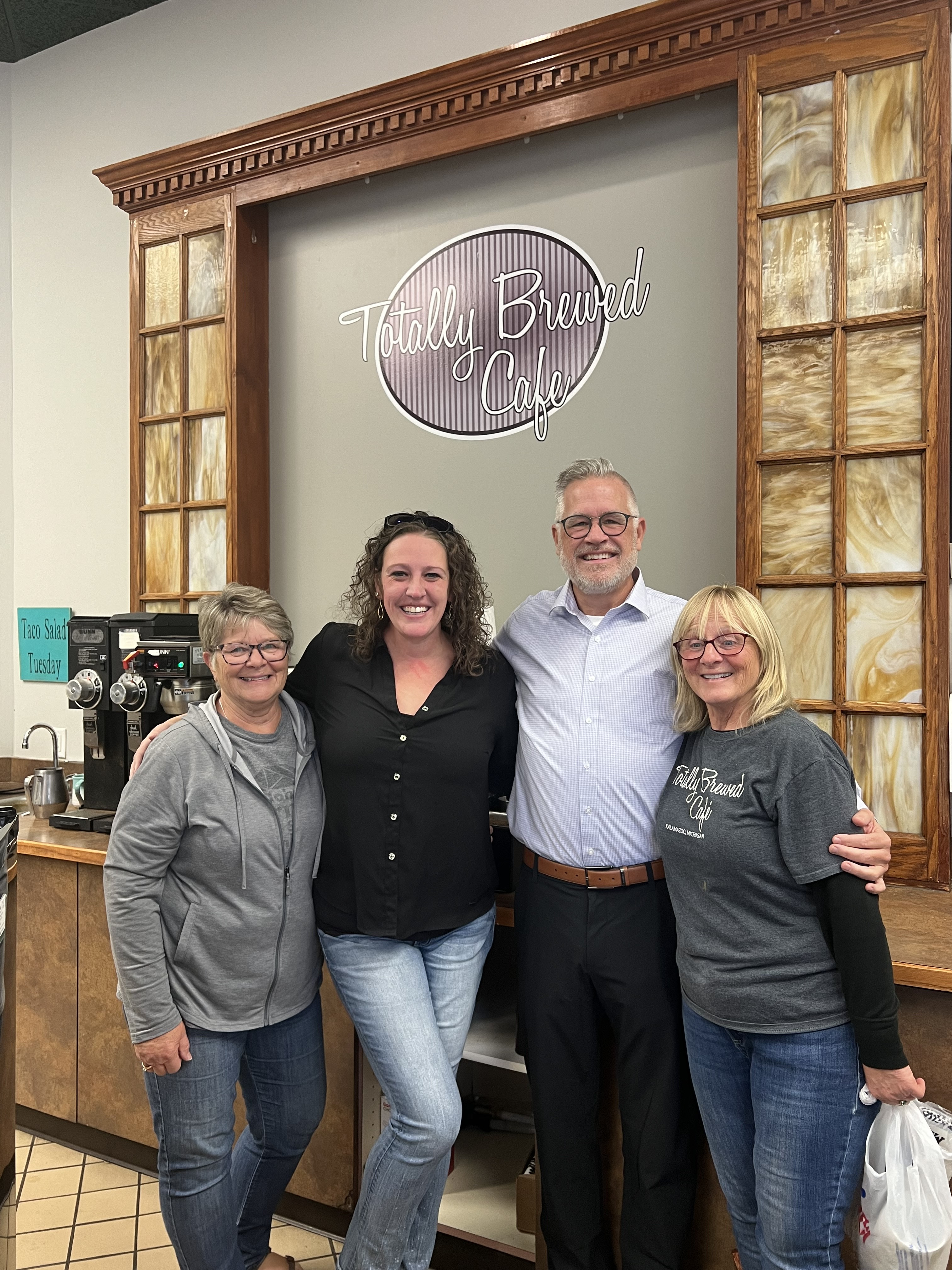 Mark Liddle poses for a photo with former Totally Brewed Cafe Owner Laurie East and the new co-owners Jess Pierson and her mother, Jennifer Nederhoed. (Photo provided by Jess Pierson) 
