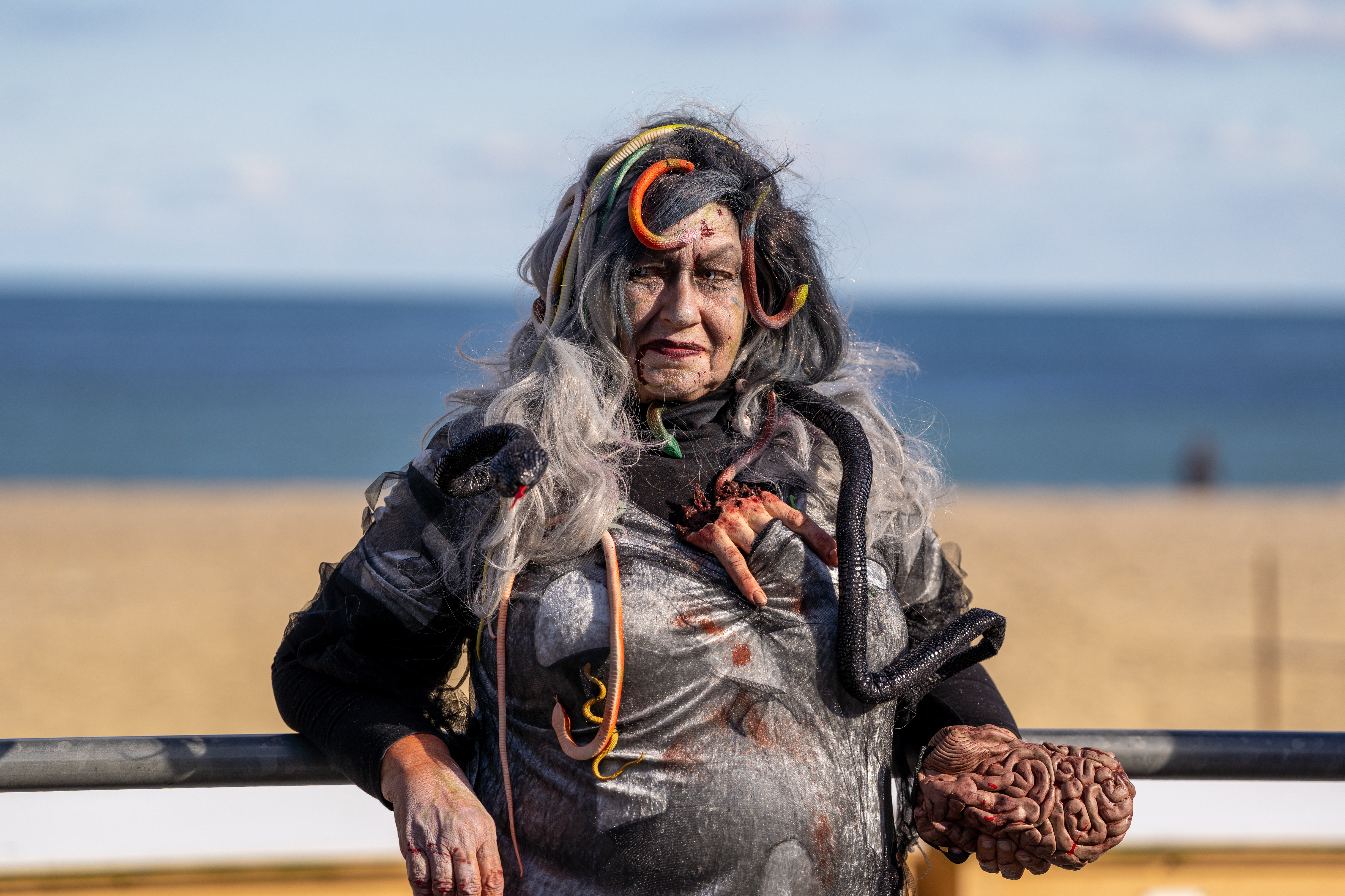 Cindy Gisinger, dressed as zombie Medusa, waits on the boardwalk for the zombie walk to begin during the 14th Asbury Park Zombie Walk in Asbury Park on Saturday, October 8, 2022. The zombie walk held its first themed year with the theme being 80's and 90's punk and metal.