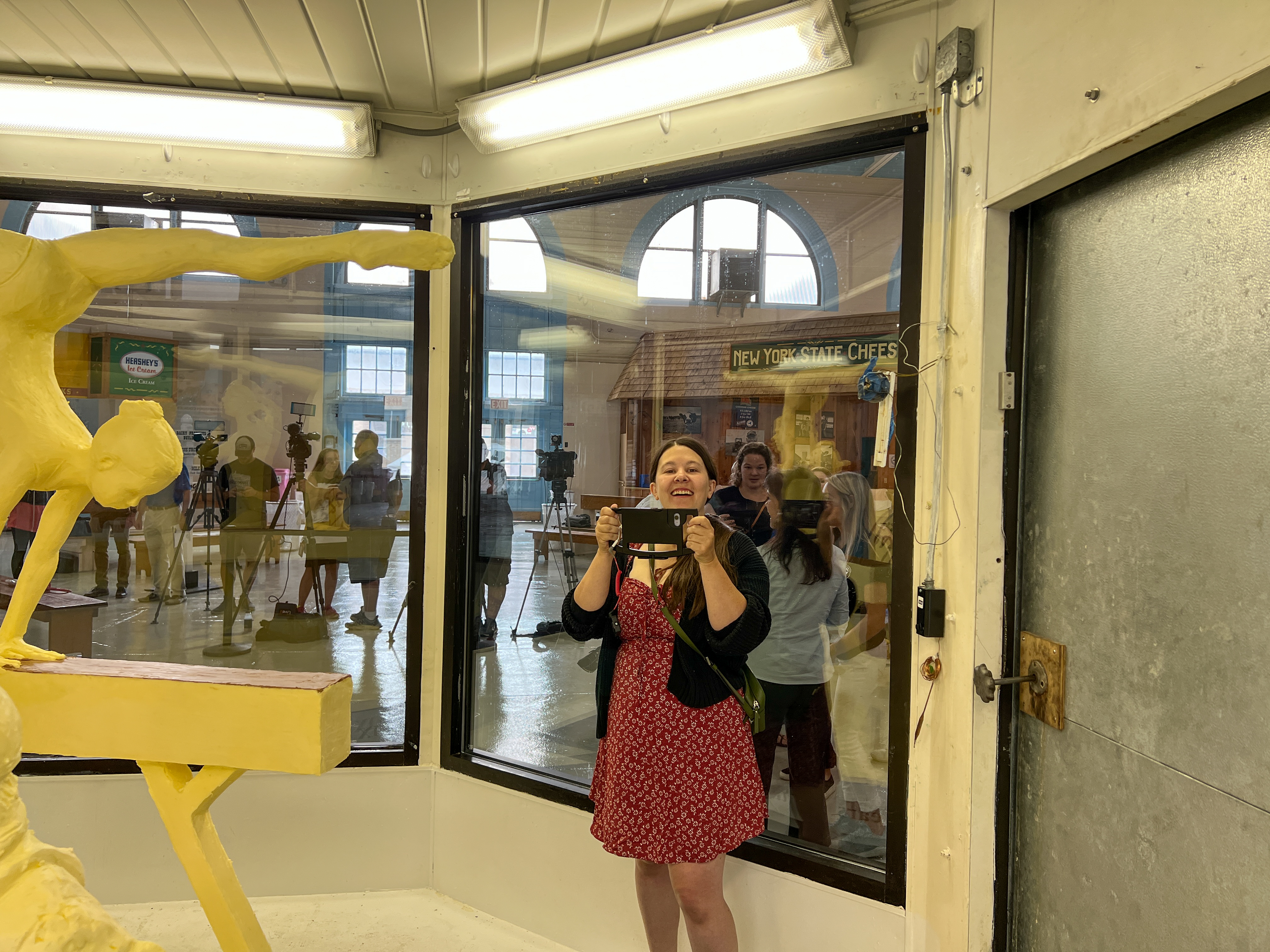 Reporter Sam House films our live coverage of the unveiling of the 2022 butter sculpture at the New York State Fair. "Refuel Her Greatness--Celebrating the 50th Anniversary of Title IX" (Charlie Miller | cmiller@syracuse.com)