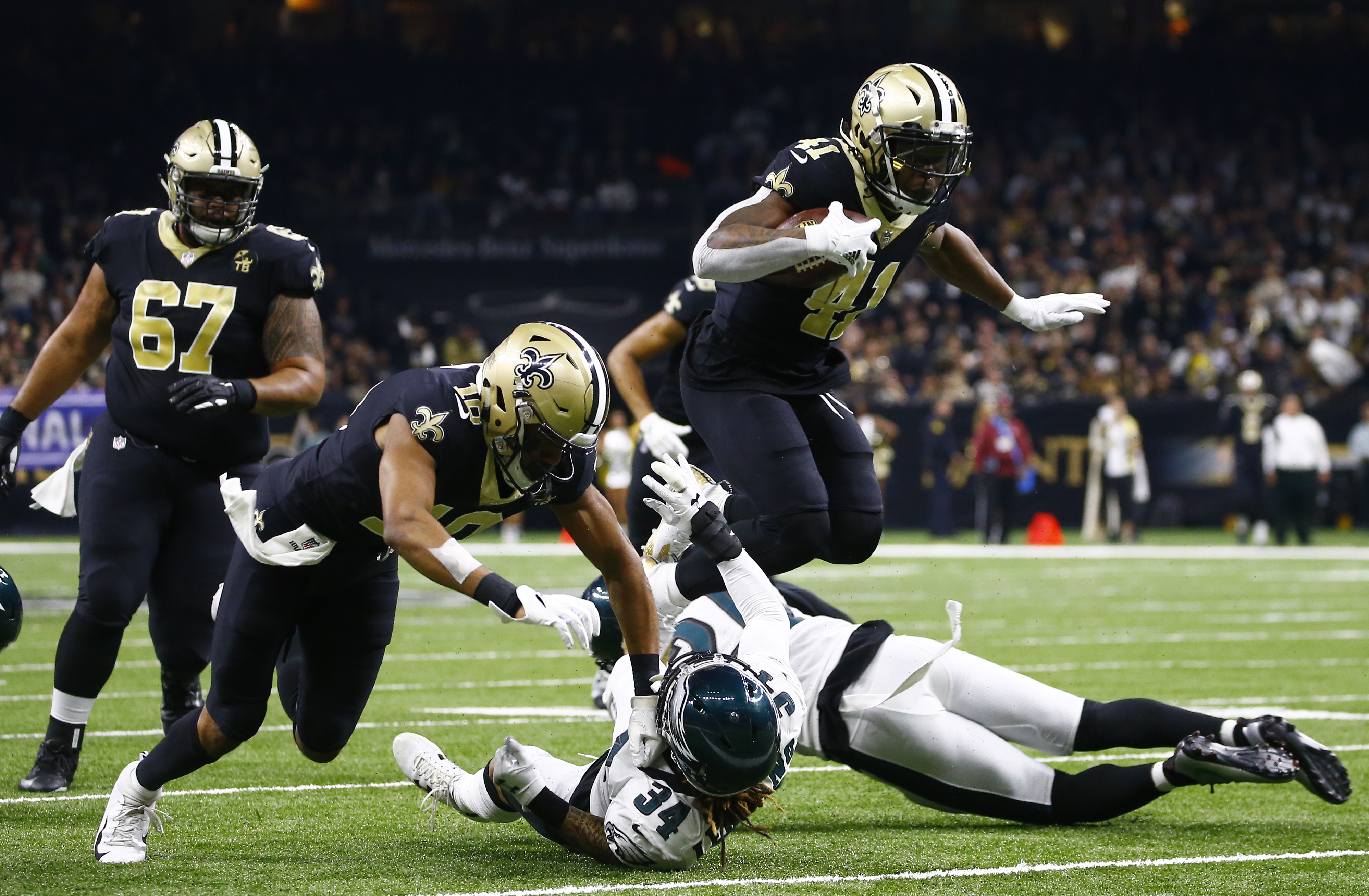 Taysom Hill New Orleans Saints Unsigned Carries The Ball in Black Jersey Photograph