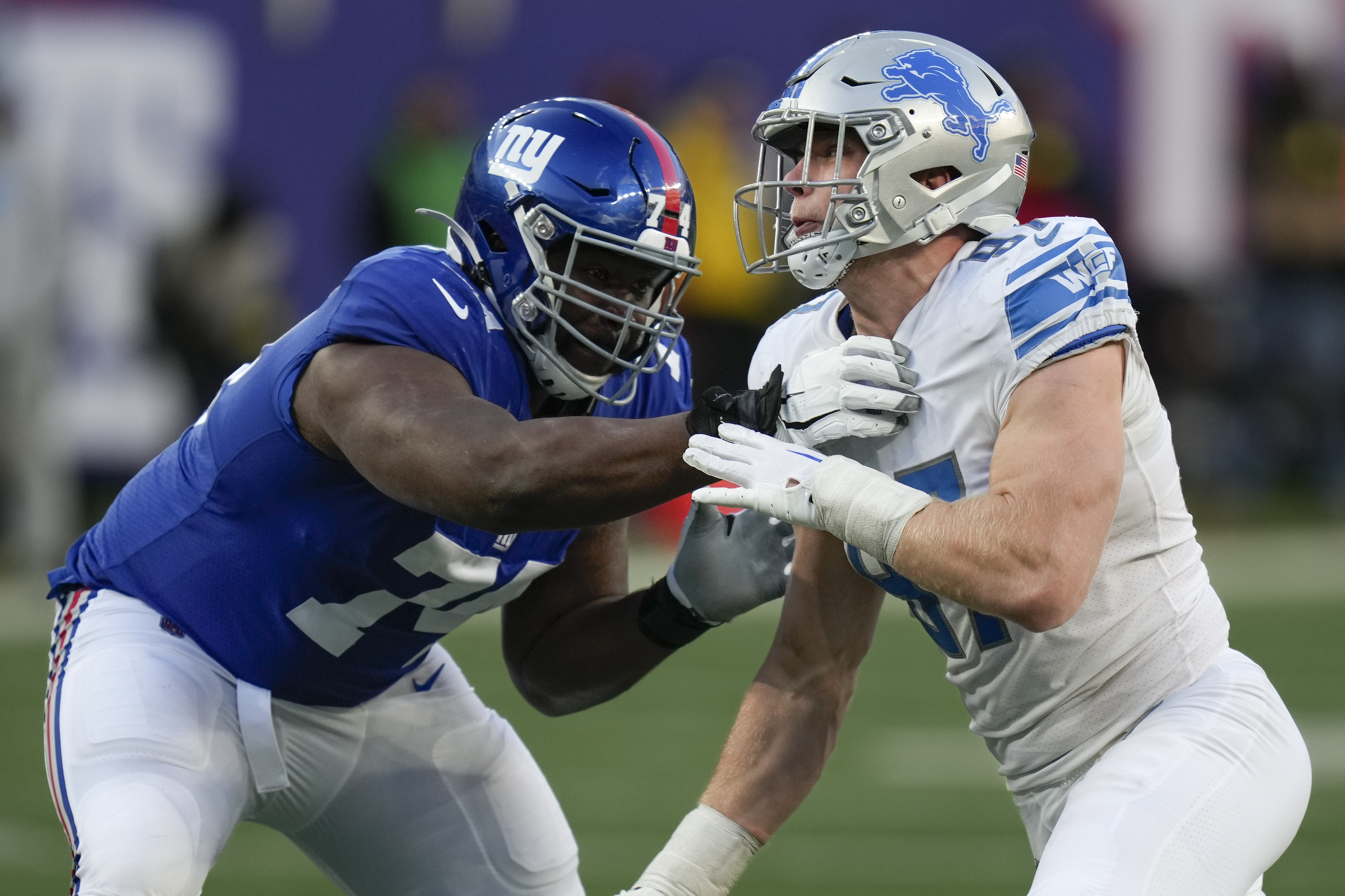 Detroit Lions wide receiver Amon-Ra St. Brown (14) runs the ball against  New York Giants cornerback Rodarius Williams (25) during the second half of  an NFL football game, Sunday, Nov. 20, 2022