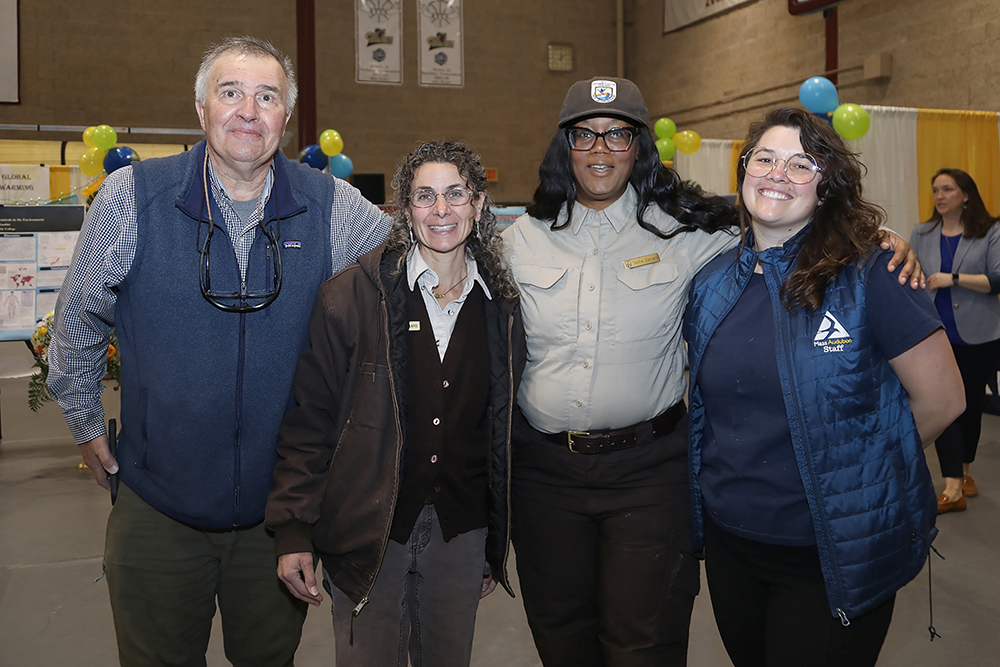 L to R- Dave Bloniarz from ReGreen Springfield, Jennifer Lapis and Tasha Daniels from the US Fish and Wildlife Service, and Aemelia Thompson form Mass Audubon at the Sustainathon event taking place in the gym in building 2 at Springfield Technical Community College on April 11th. (Ed Cohen Photo)