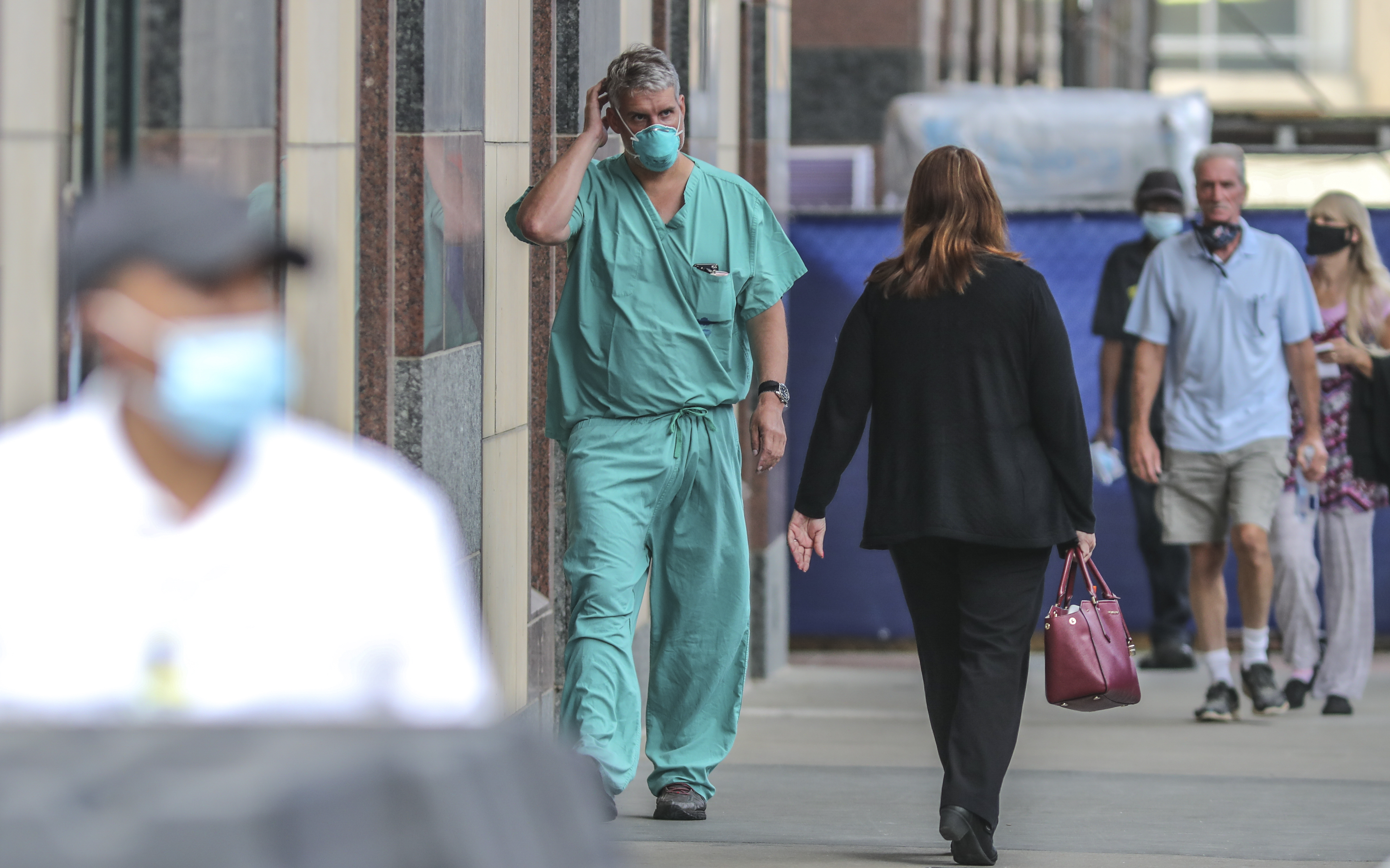 Dr. Chris Sadlack (center) walks outside Grady Hospital in downtown Atlanta on Thursday, July 9, 2020. Grady who along with other local hospitals are seeing a surge in new patients as cases reach record highs in Georgia. Grady is also experiencing a spike in trauma care patients. JOHN SPINK/JSPINK@AJC.COM