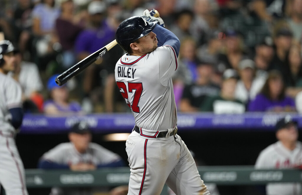 Atlanta Braves' Austin Riley follows the flight of his solo home run off Colorado Rockies starting pitcher Kyle Freeland in the sixth inning of a baseball game Saturday, June 4, 2022, in Denver. (AP Photo/David Zalubowski)