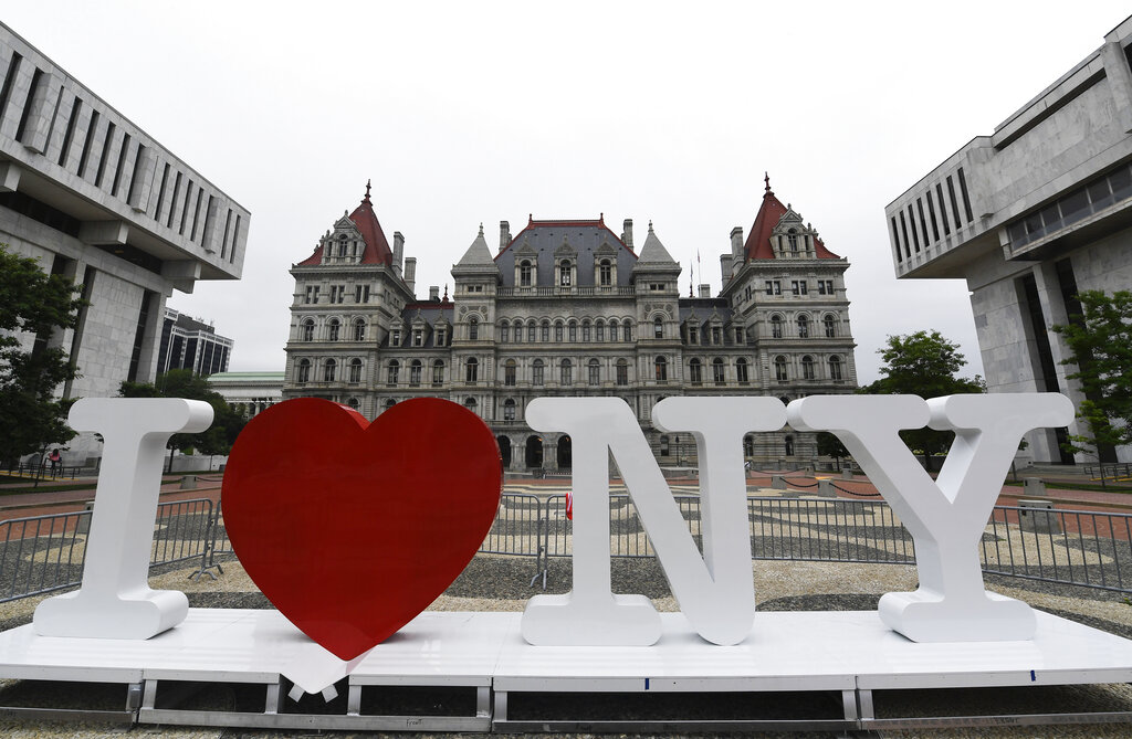 FILE - In this Tuesday, June 18, 2019, file photo, a new promotional "I Love NY" sign sits in the Empire State Plaza for installation in front of the New York state Capitol in Albany, N.Y. Milton Glaser, the designer who created the "I (HEART) NY" logo and the famous Bob Dylan poster with psychedelic hair, died Friday, June 26, 2020, his 91st birthday. (AP Photo/Hans Pennink, File)
